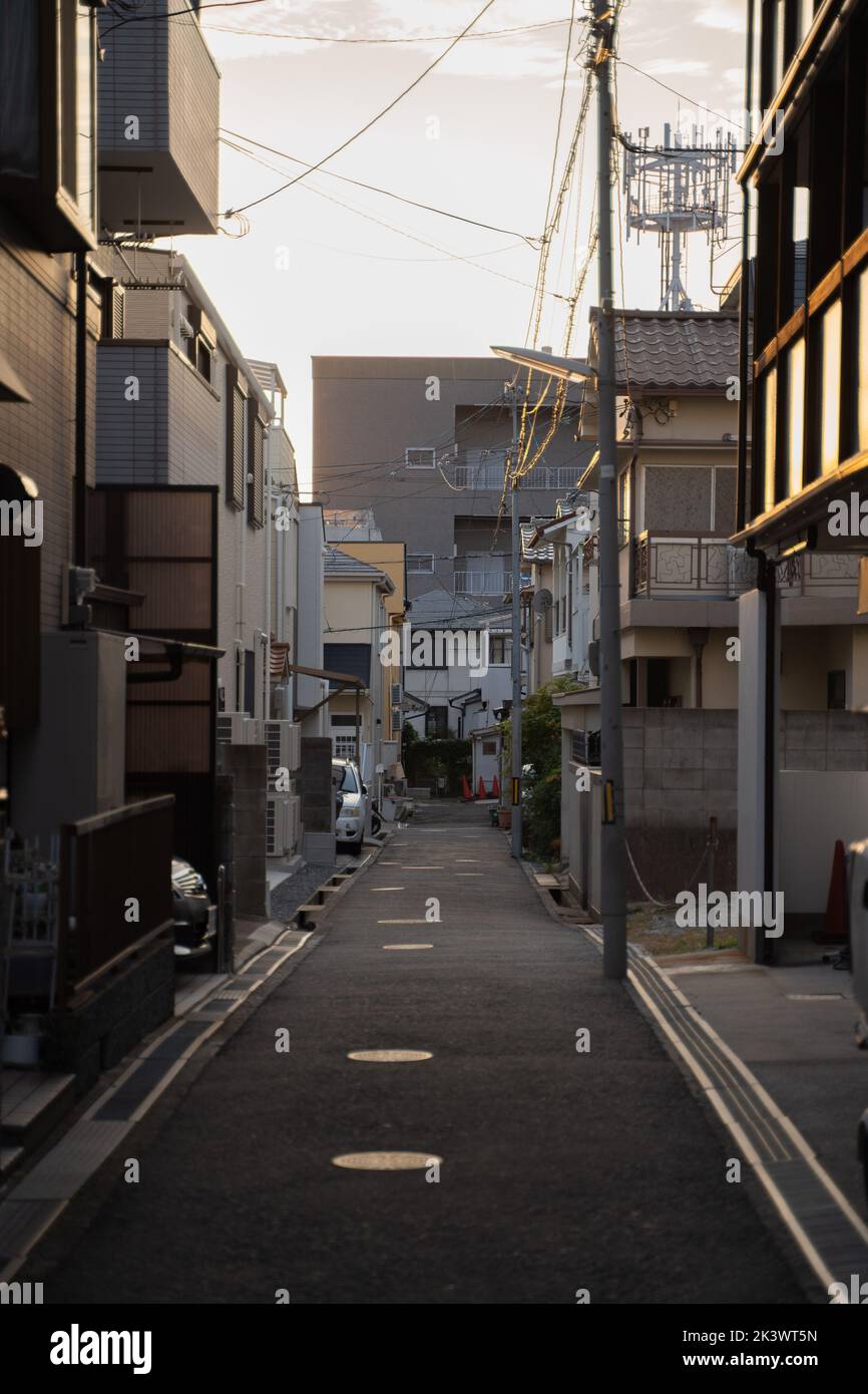 A vertical shot of calm Street houses of Kobe, Japan under sunset sky Stock Photo