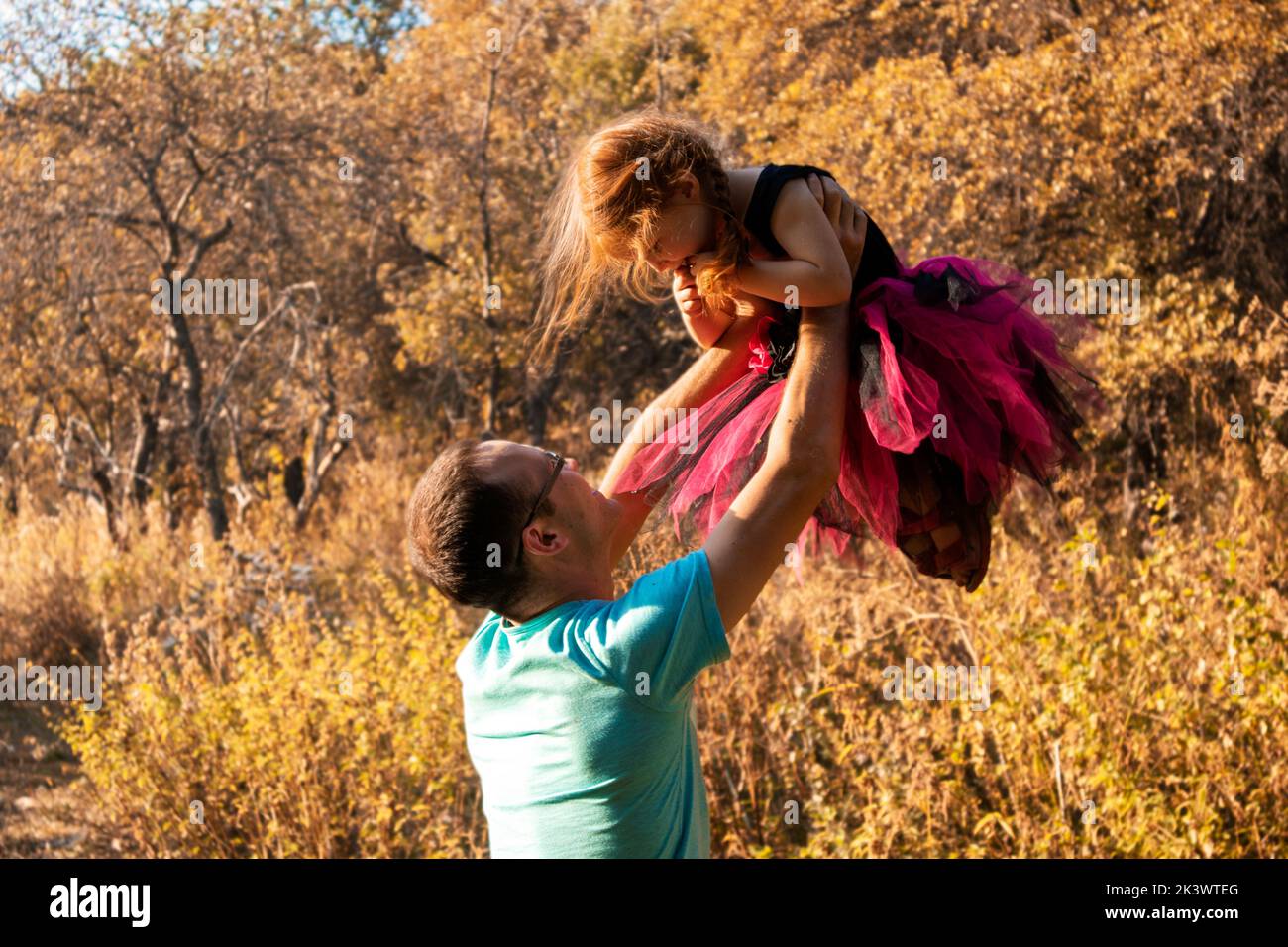 dad and daughter are dancing in nature.a little ballerina dances with her dad. little princess.dad holds his daughter in his arms. dance support Stock Photo