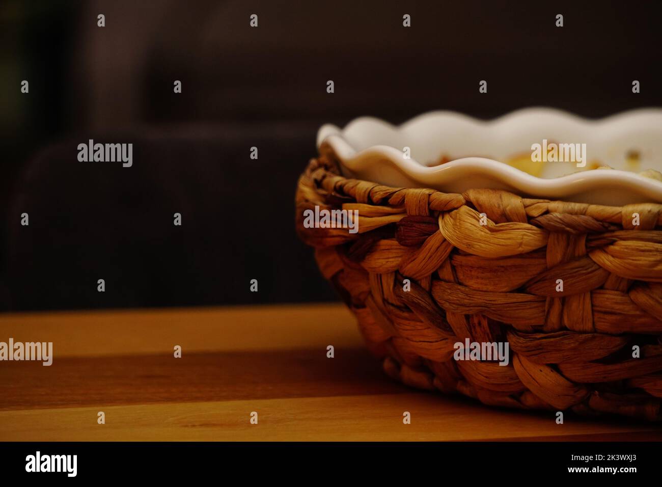 The close-up partial view of a decorative bowl over the wooden surface Stock Photo