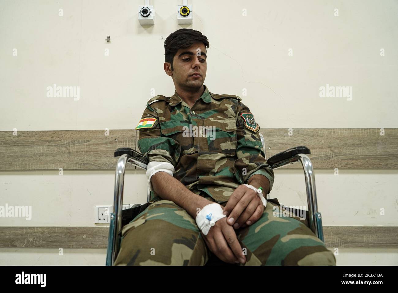 28 September 2022, Iraq, Erbil: A wounded member of the opposition Kurdistan Freedom Party (PAK) sits on a wheelchair at a hospital following attacks by Iranian explosives-laden drones and rockets targeting the opposition Kurdistan Freedom Party (PAK), the Kurdistan Democratic Party of Iran (KDPI), the Free Life Party of Kurdistan (PJAK), and Komala in the provinces of Erbil and Sulaymaniyah, Kurdish media reported. The death toll from the attacks on opposition groups in the autonomous region of Kurdistan rose to nine and at least 32 were also injured, Iraq's state news agency INA quoted Barzi Stock Photo