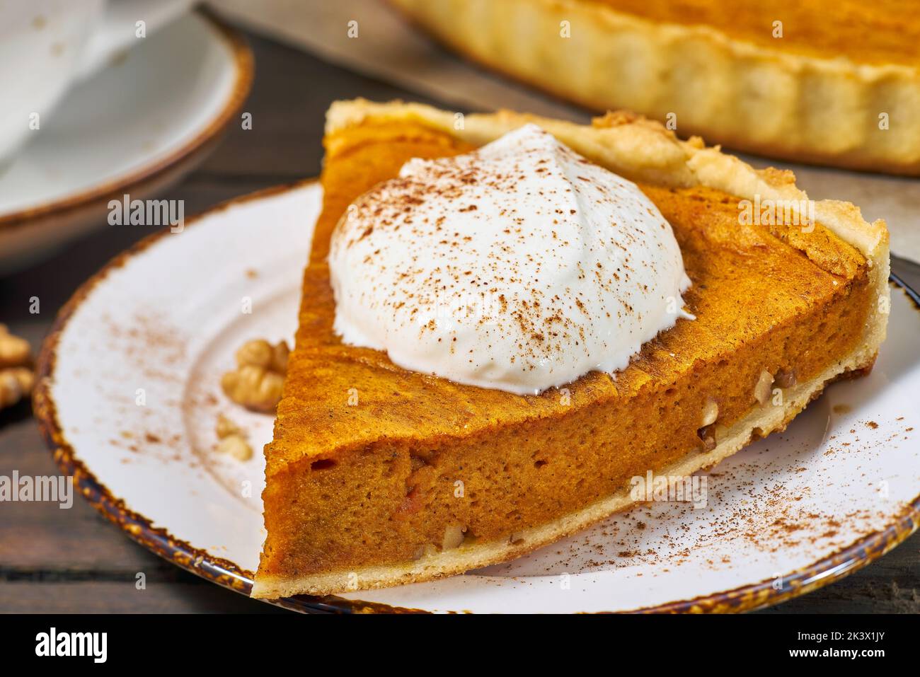 Piece of pumpkin pie with whipped cream. Selective focus Stock Photo