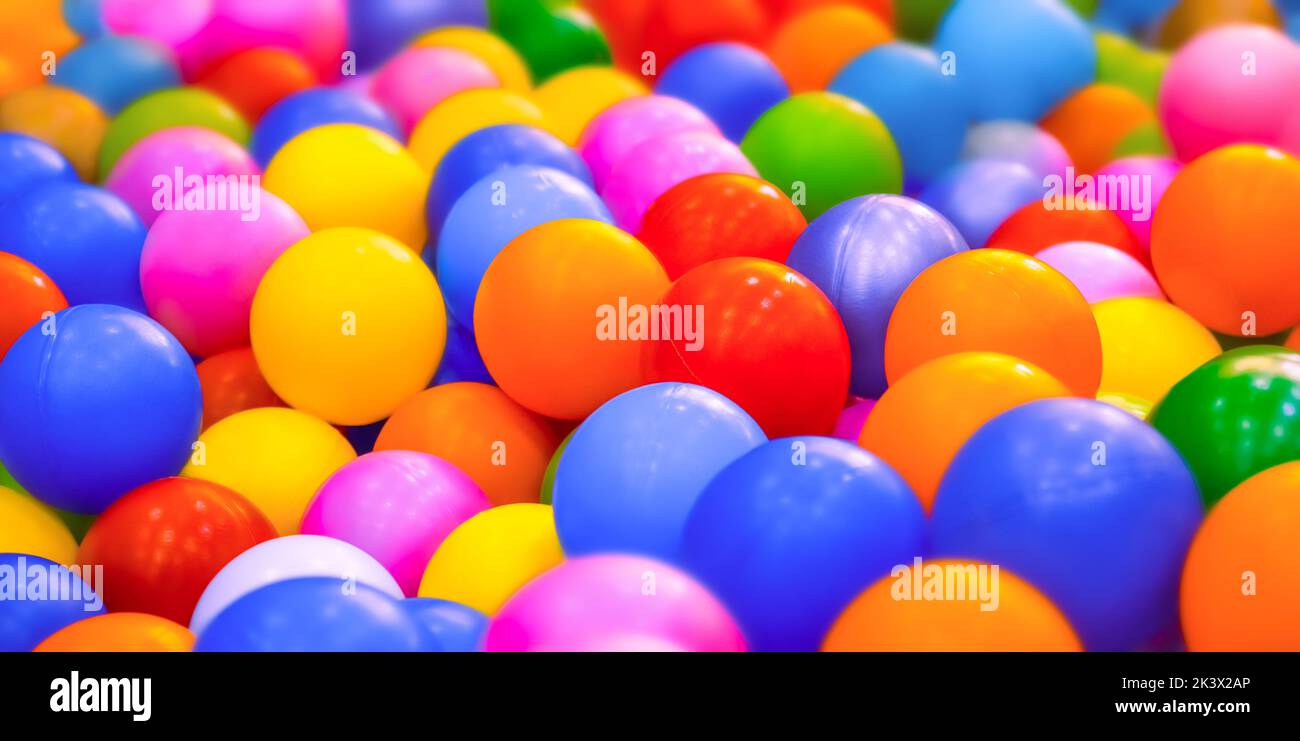 Dry pool or kids ball pit. Many colorful balls background playground balls pool plastic. Entertainment banner kids play zone or kids zone Stock Photo