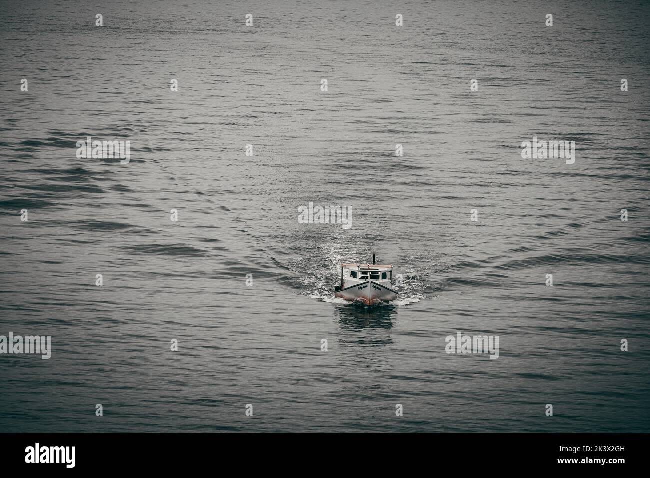 A boat speeding through the bay Stock Photo - Alamy
