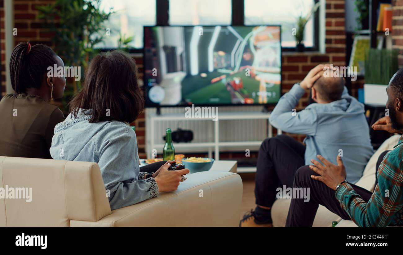 Diverse people playing video games to have fun at home, enjoying online ...