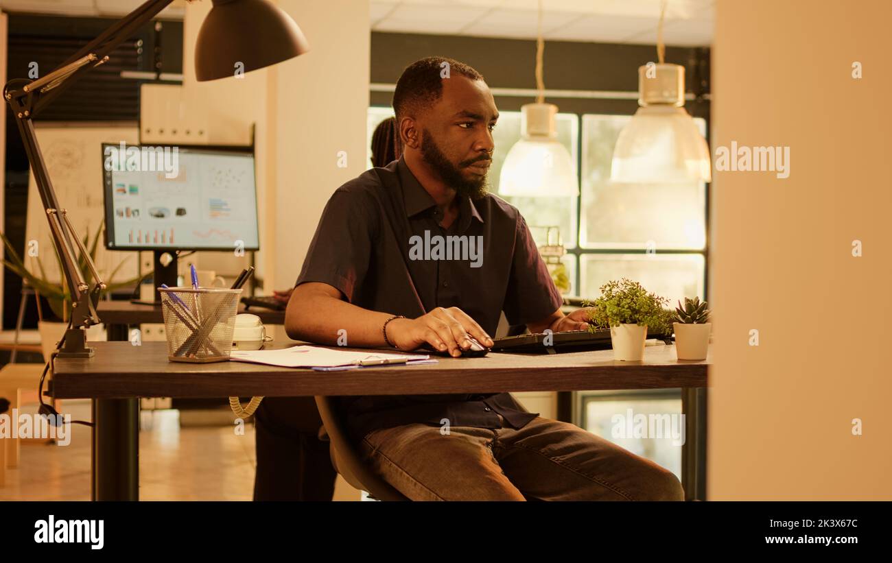 Company employee working on presentation report at job, analyzing ...