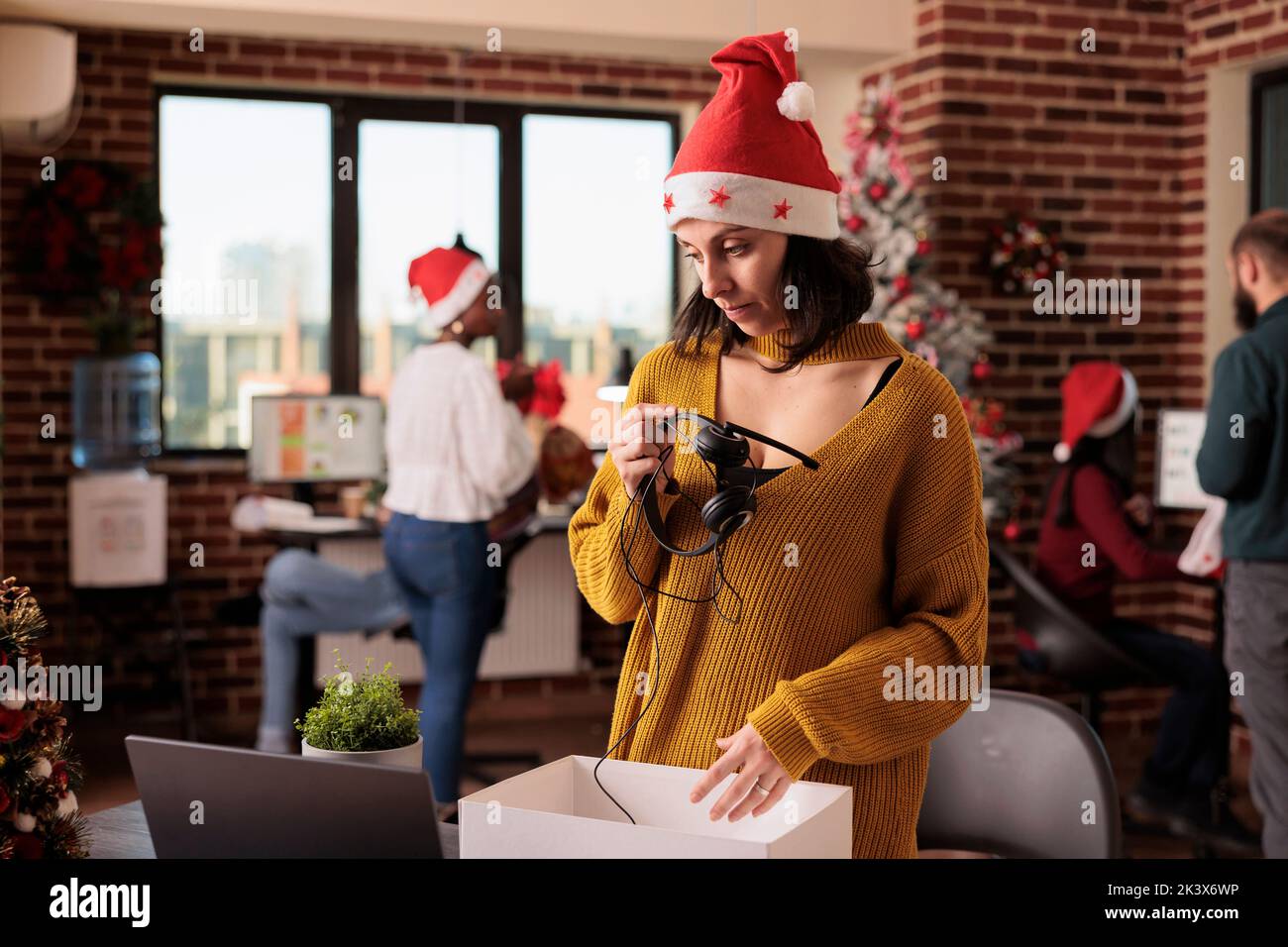 Depressed woman getting fired on christmas eve day, feeling sad and frustrated about career failure. Being dismissed and discharged, feeling unhappy about lost job and unemployment. Stock Photo