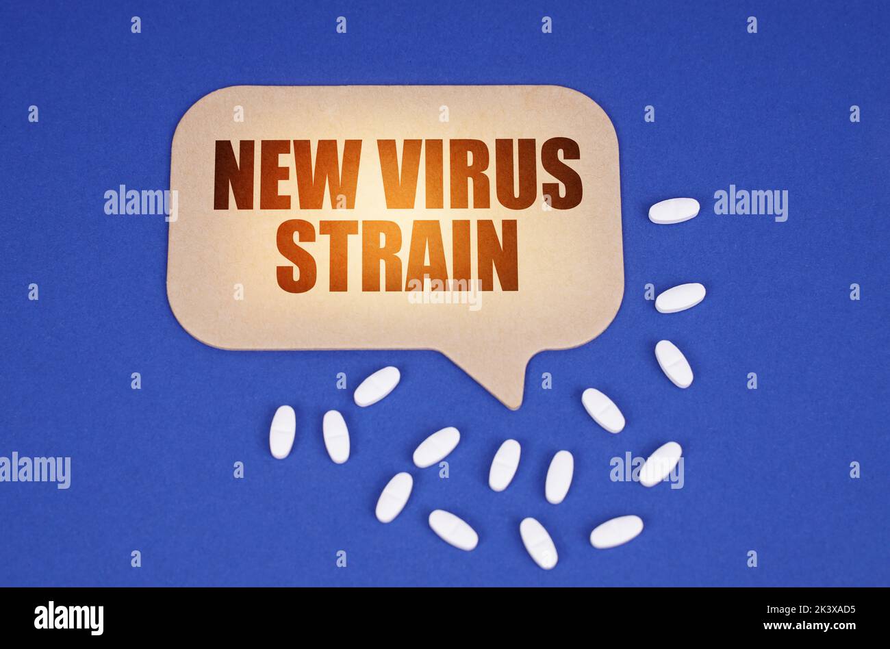 Medical concept. On the blue surface of the tablet and a cardboard plate with the inscription - New virus strain Stock Photo