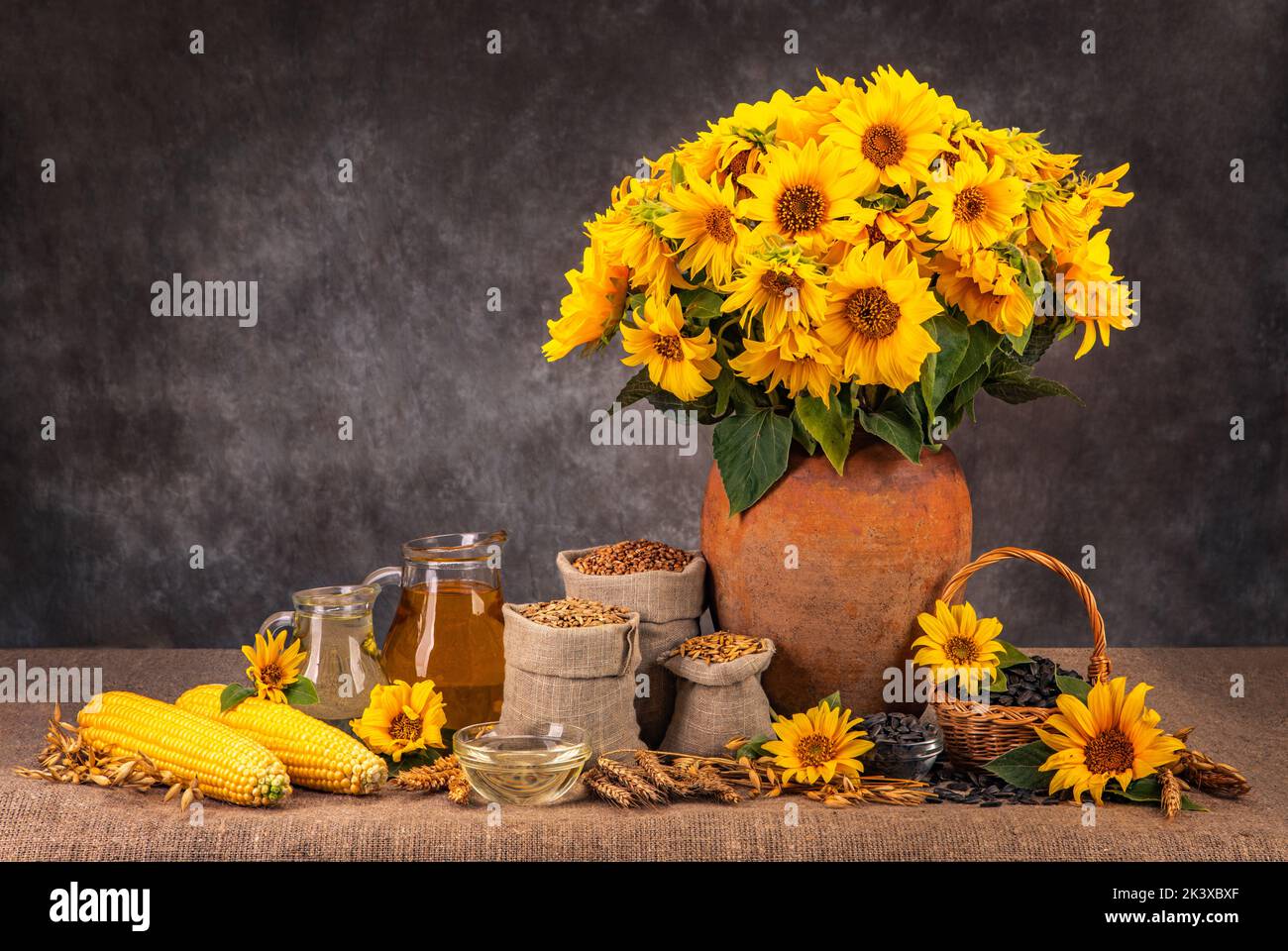 Still life with sunflowers and fruits of the harvest. Spikelets of