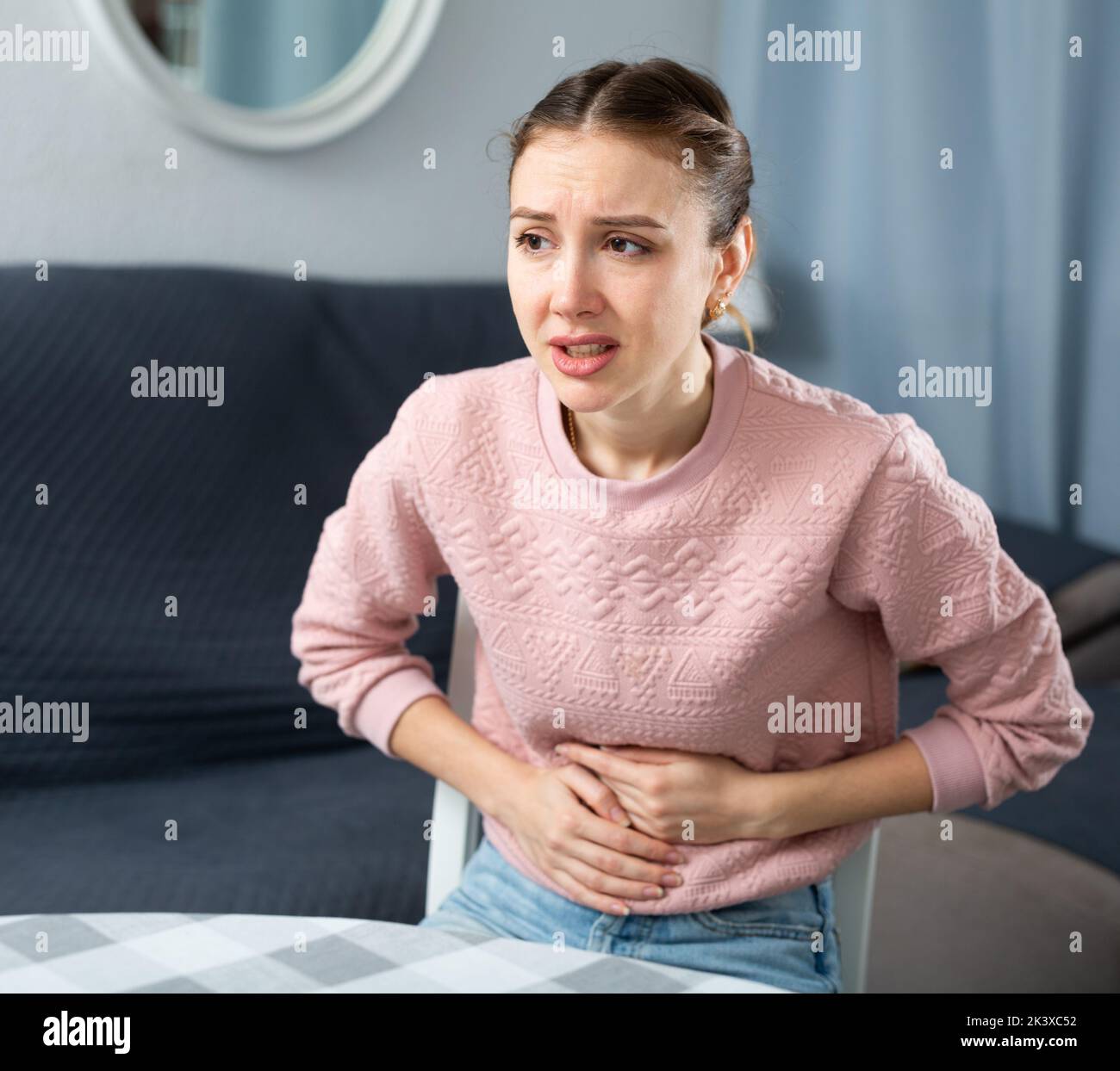 Young woman suffering from abdominal pain Stock Photo