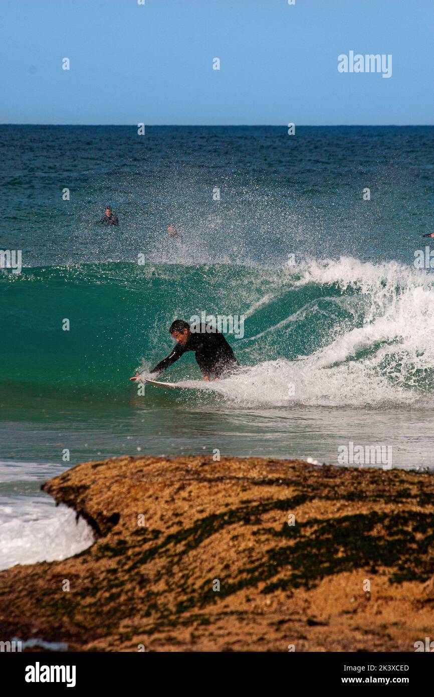 A vertical shot of a surfer in the sea at the north end of Maroubra Beach, Sydney, Australia Stock Photo