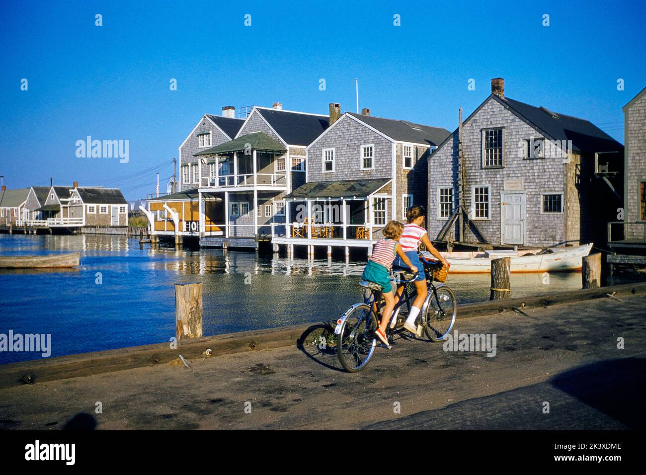 Two Young Girls riding Tandem Bicycle, Nantucket, Massachusetts, USA, Toni Frissell Collection, September 1957 Stock Photo