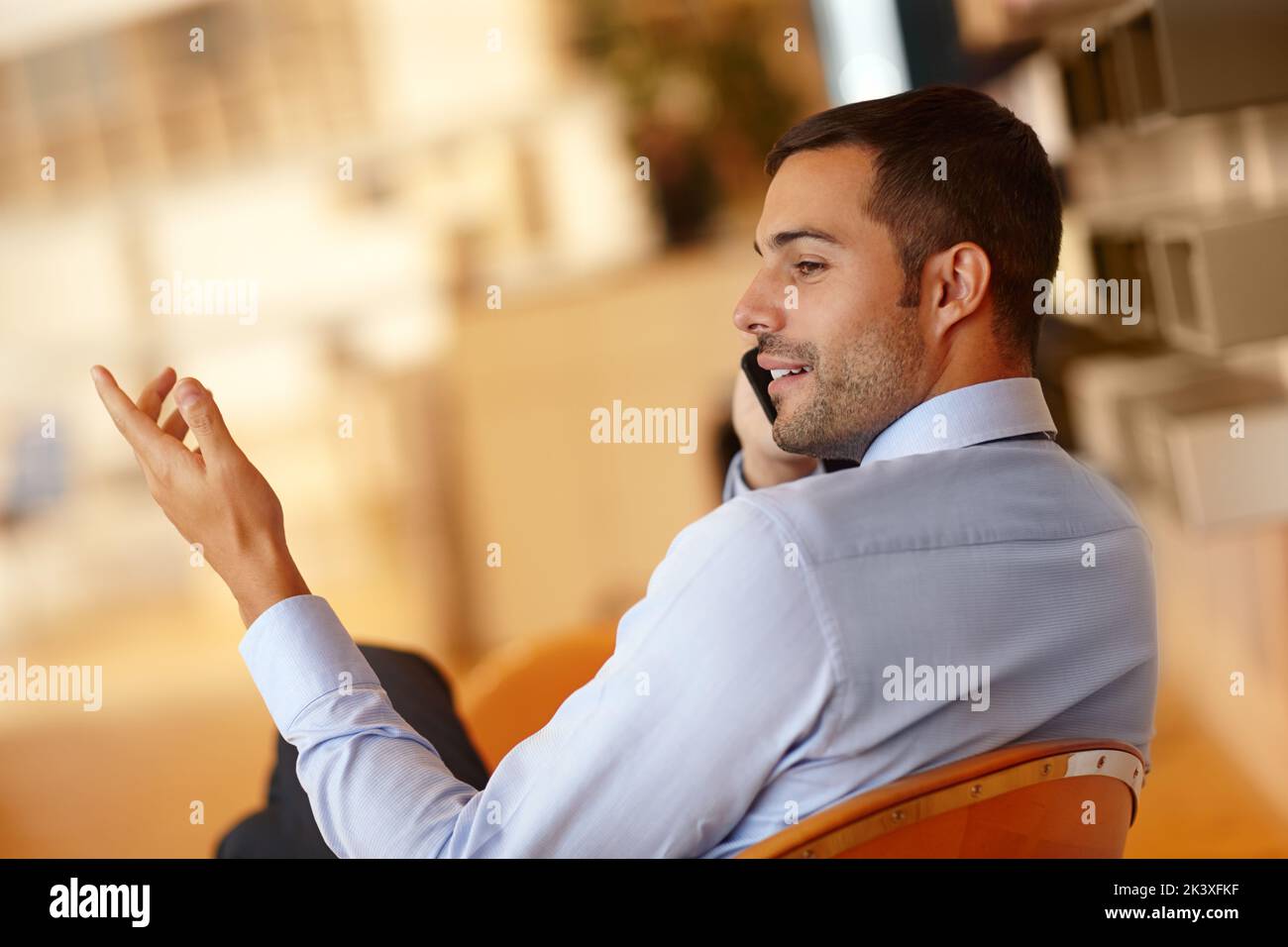 Let me explain the terms once more...A handsome young businessman making use of his smartphone. Stock Photo
