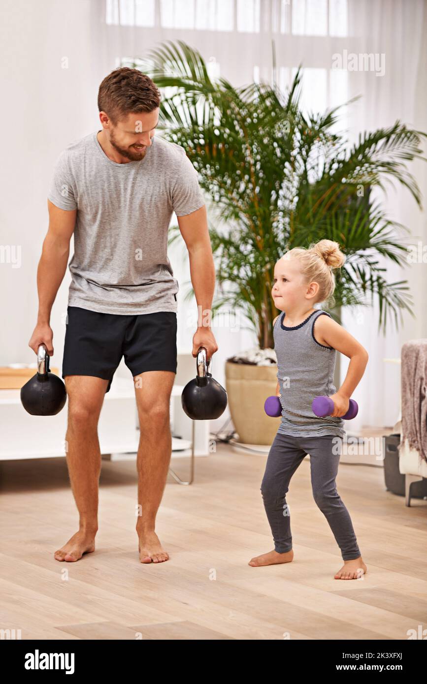 Strengthening their bond. Full length shot of a father and daughter working out together. Stock Photo
