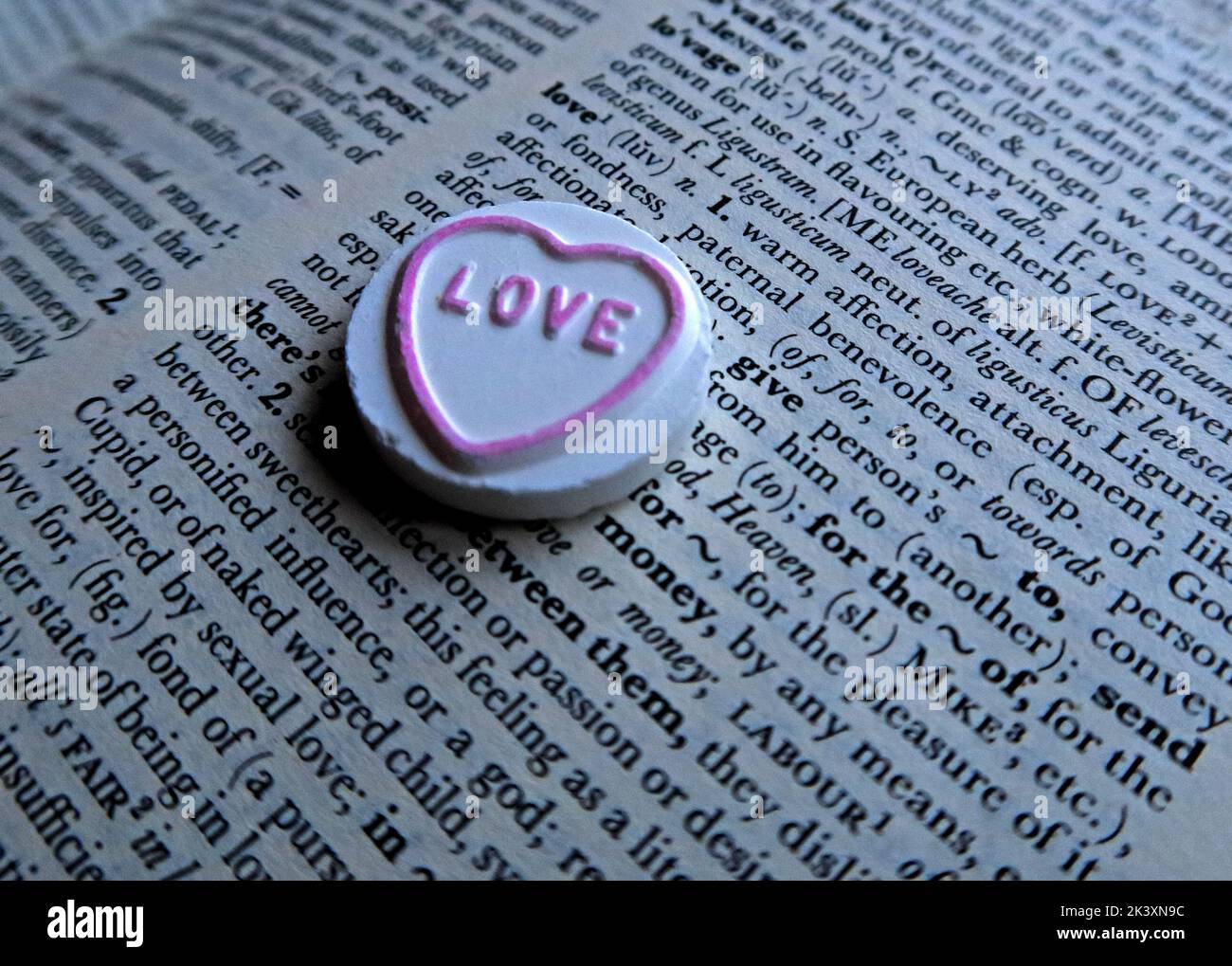 Love Heart, sitting on a dictionary definition of 'Love' Stock Photo