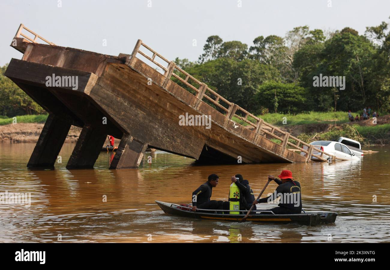 Rescue workers navigate on boats at Curuca river after a bridge collapsed in BR-319 road in Careiro da Varzea, near Manaus, Brazil, September 28, 2022. REUTERS/Bruno Kelly Stock Photo