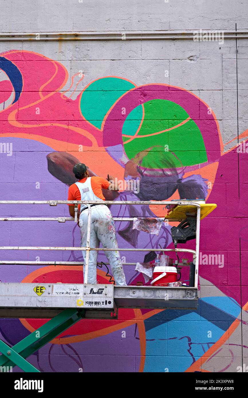 An artist creates a new mural during the 2022 RVA Street Art Festival