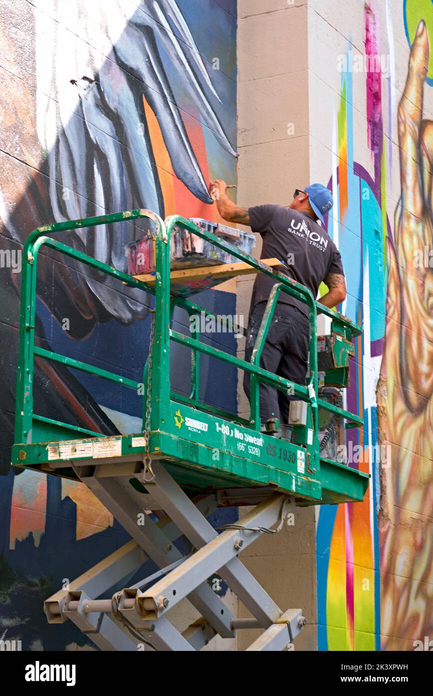 Artist Ed Trask creates a new mural during the 2022 RVA Street Art Festival at the Power Plant along Richmond VA's Canal Walk. Stock Photo