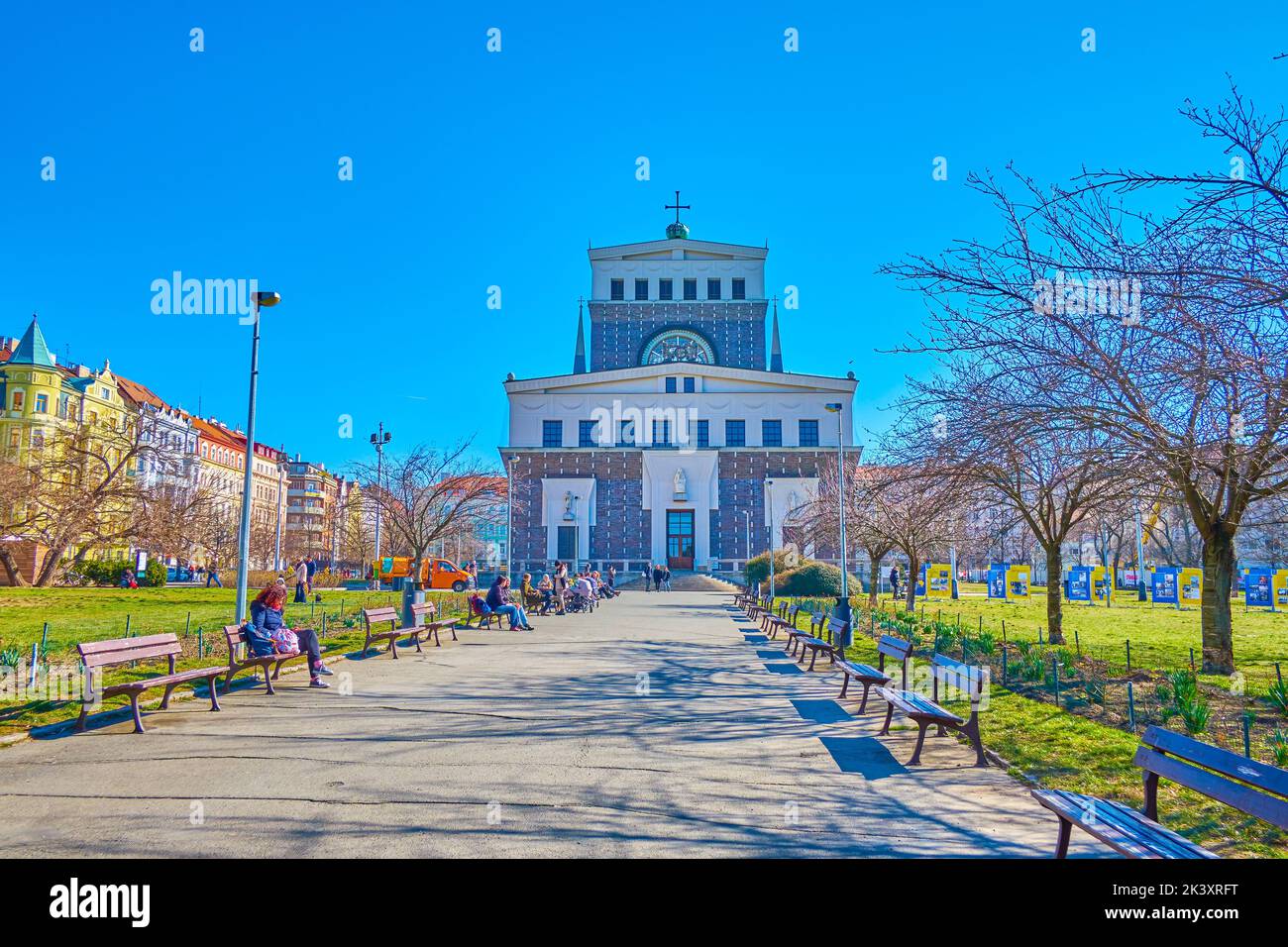 PRAGUE, CZECH REPUBLIC - MARCH 12, 2022: The alley in urban park Jiriho z Podebrad with modern Church of the Most Sacred Heart of Our Lord, on March 1 Stock Photo