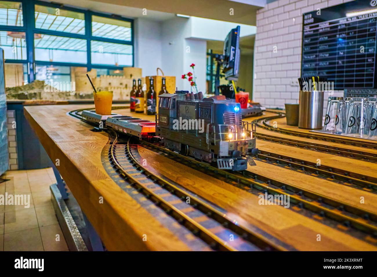 PRAGUE, CZECH REPUBLIC - MARCH 12, 2022: The small train delivering beverage to the client of Vytopna restaurant, on March 12 in Prague, Czech Republi Stock Photo