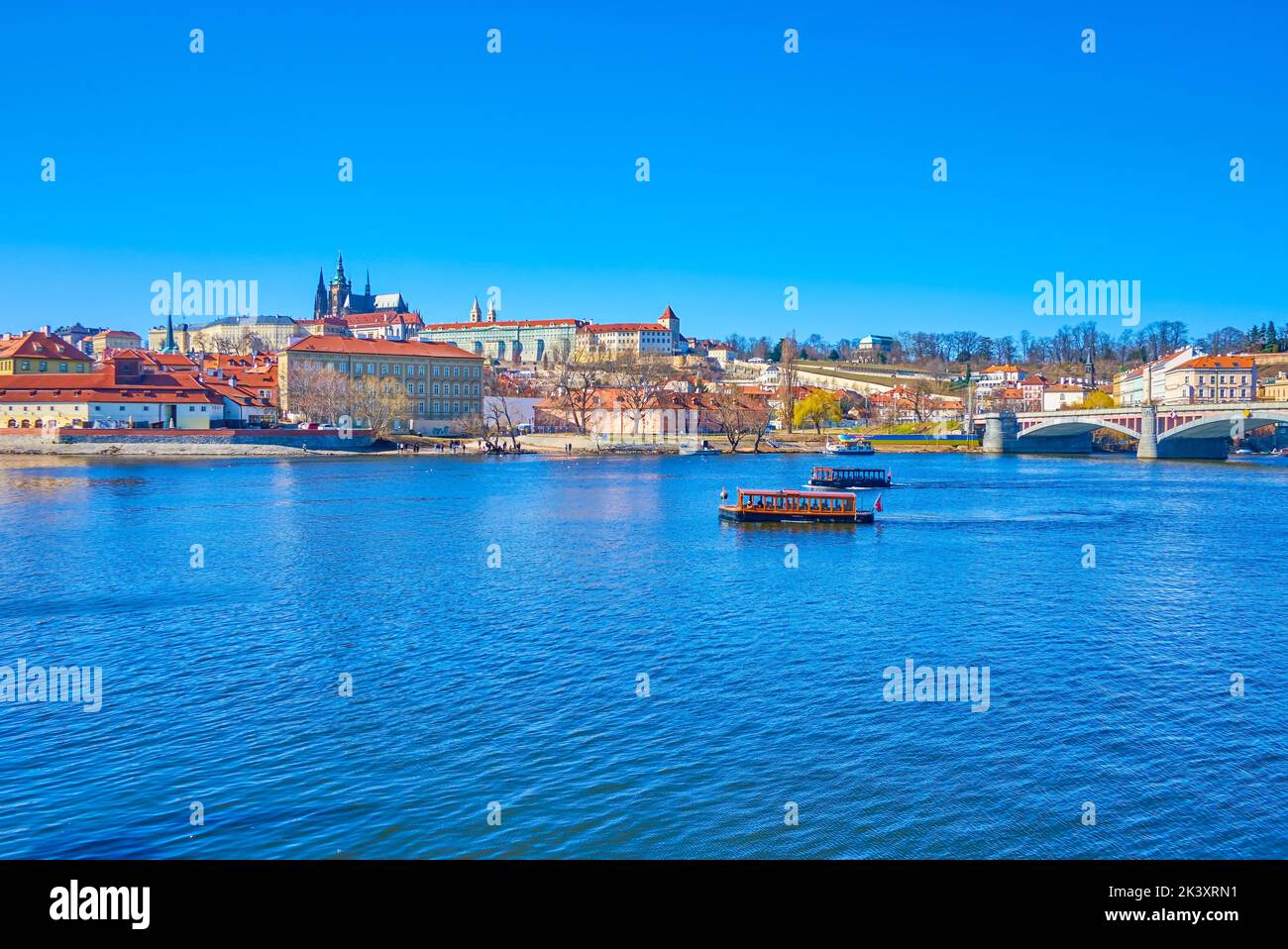 Vltava river with tourist boats and Mala Strana district with its landmarks, Prague, Czech Republic Stock Photo