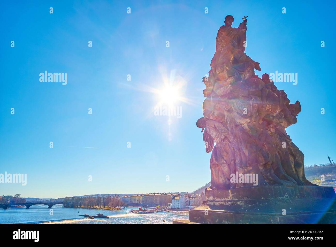 The historical sculpture on Karluv Most (Charles Bridge) and bright sunbeam, Prague, Czech Republic Stock Photo