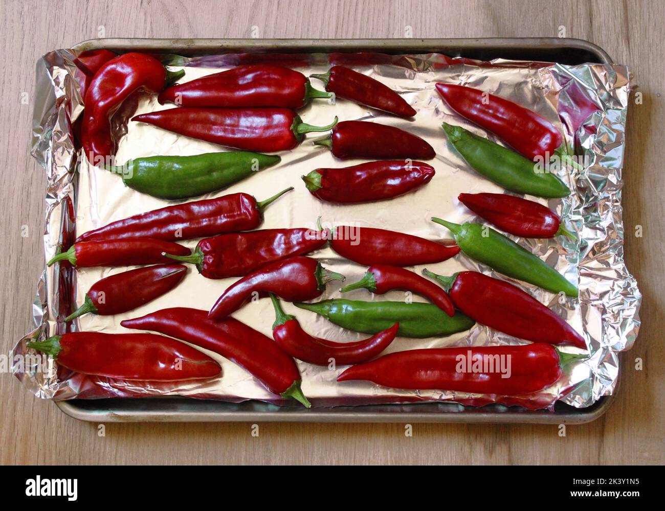 Green and Red Hatch Chile Peppers Laid Out on a FoilLined Baking Sheet