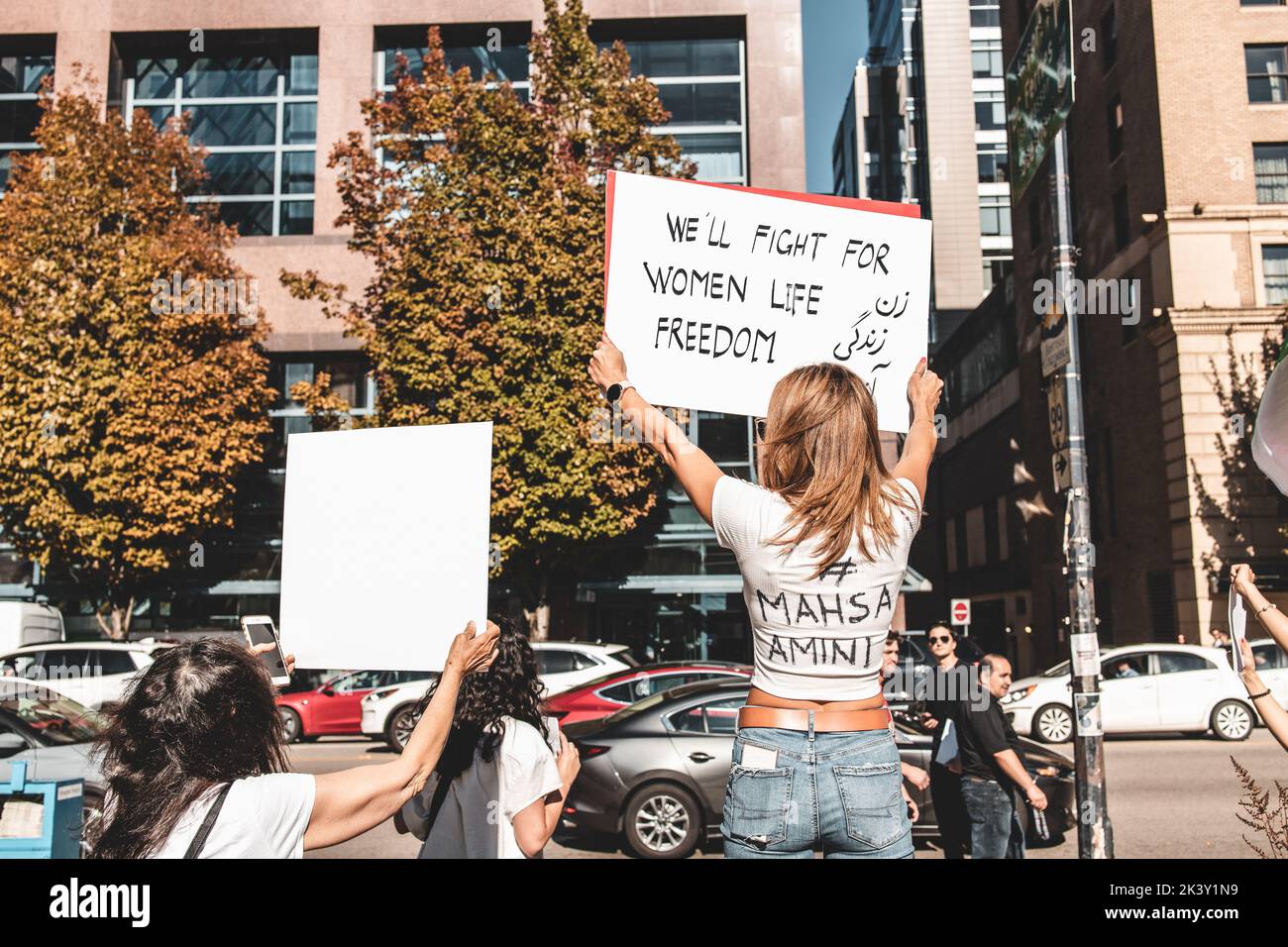 Vancouver, Canada - September 25,2022: Huge rally in support of Iranian protests in front of Vancouver Art Gallery. Woman with a sign we will fight fo Stock Photo