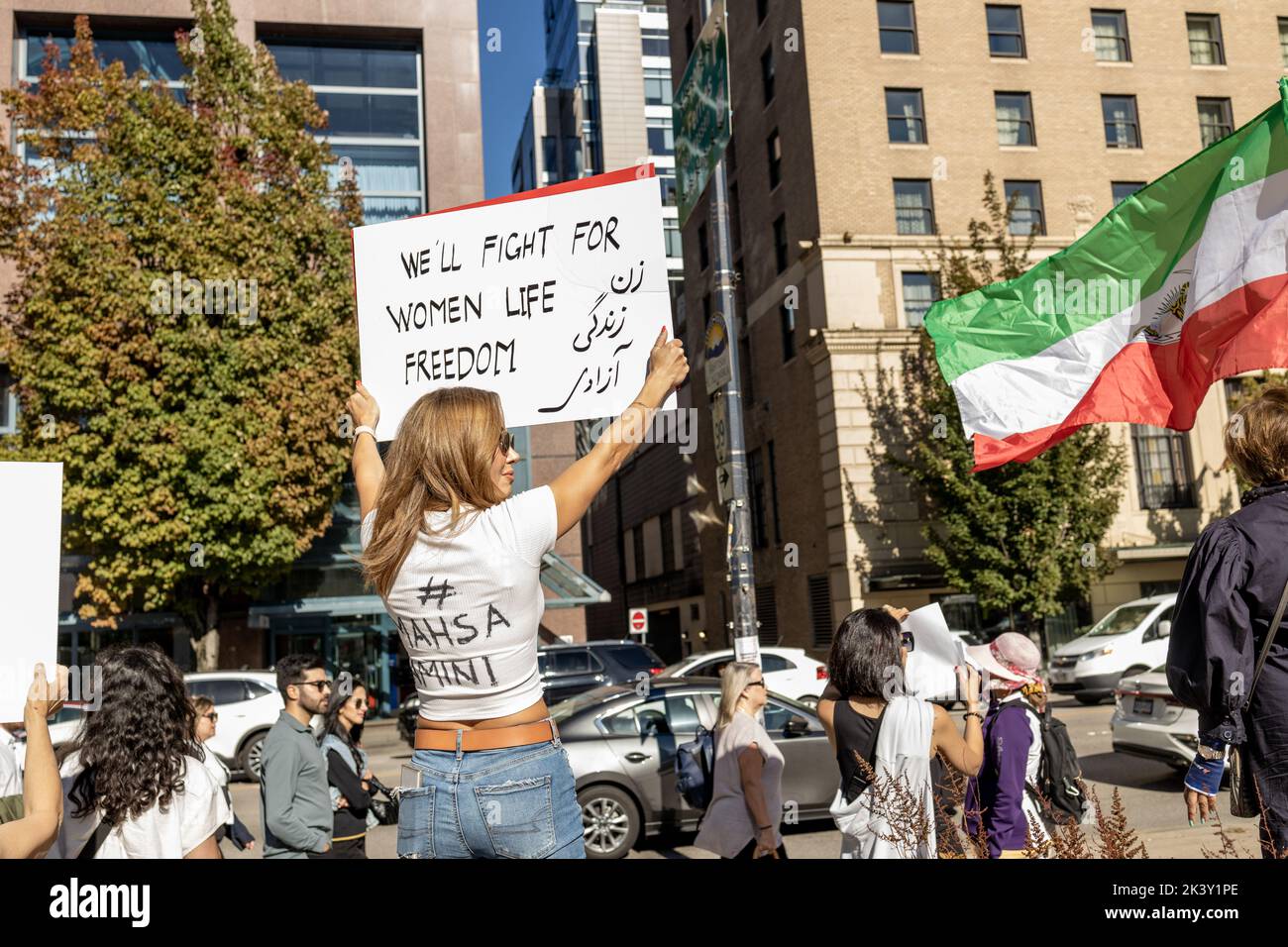 Vancouver, Canada - September 25,2022: Huge rally in support of Iranian protests in front of Vancouver Art Gallery. Woman with a sign we will fight fo Stock Photo