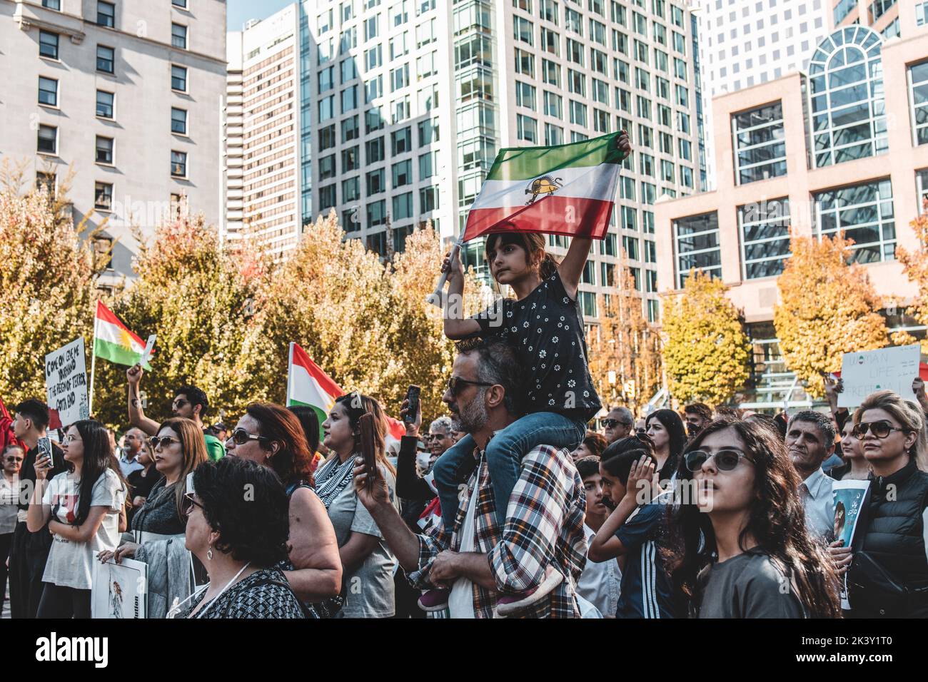 Vancouver, Canada - September 25,2022: Huge rally in support of Iranian protests in front of Vancouver Art Gallery. Little girl with Iranian Flag Stock Photo