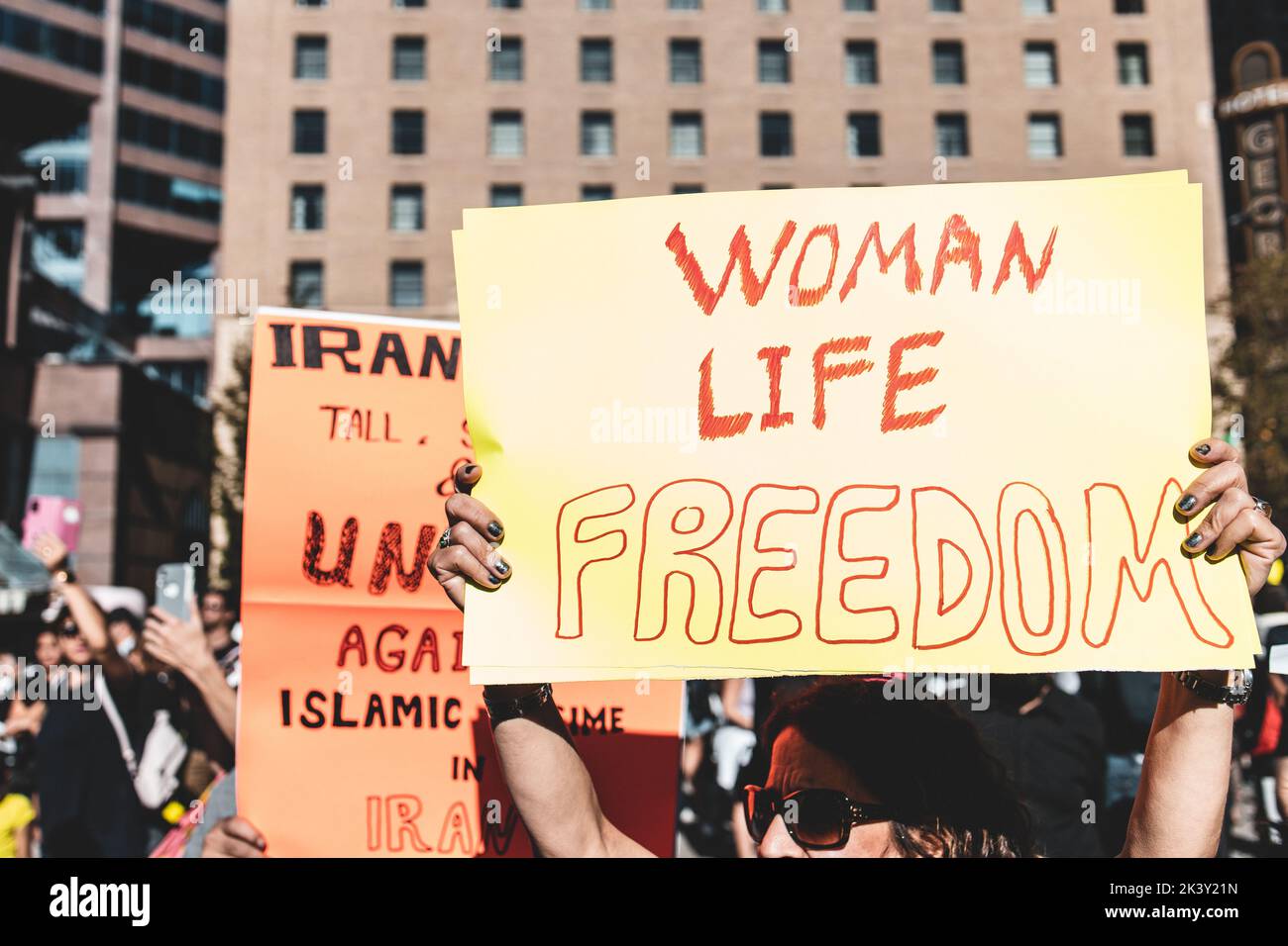 Vancouver, Canada - September 25,2022: Huge rally in support of Iranian protests in front of Vancouver Art Gallery. Woman with a sign Woman Life Freed Stock Photo