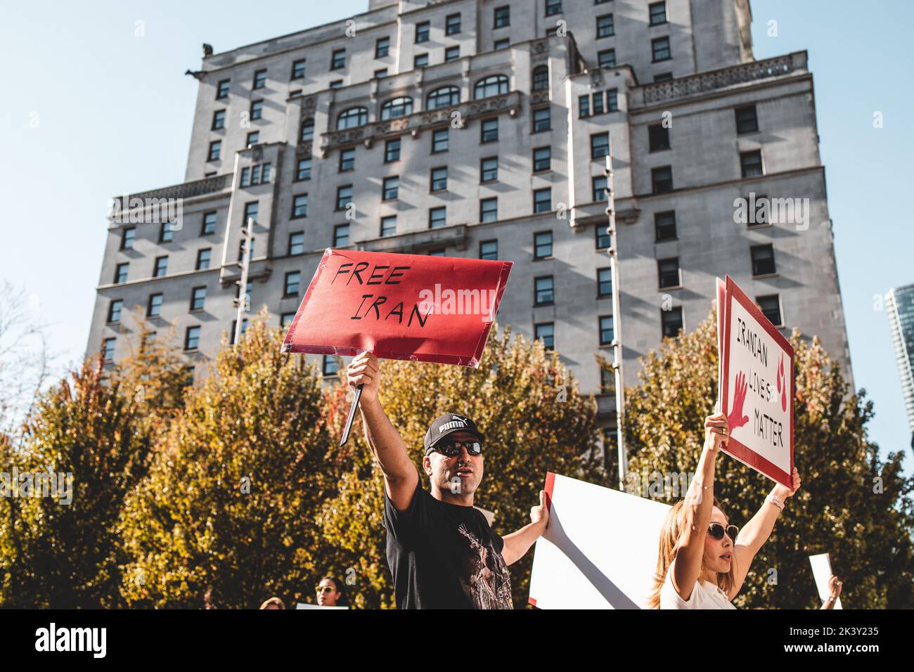 Vancouver, Canada - September 25,2022: Huge rally in support of Iranian protests in front of Vancouver Art Gallery. Man with a sign Free Iran Stock Photo