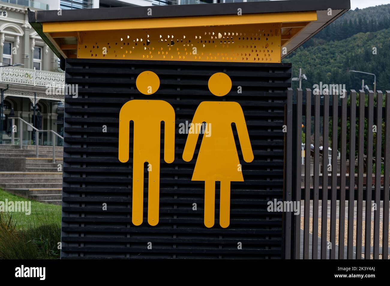 Bright yellow icons label a public convenience or toilet Stock Photo