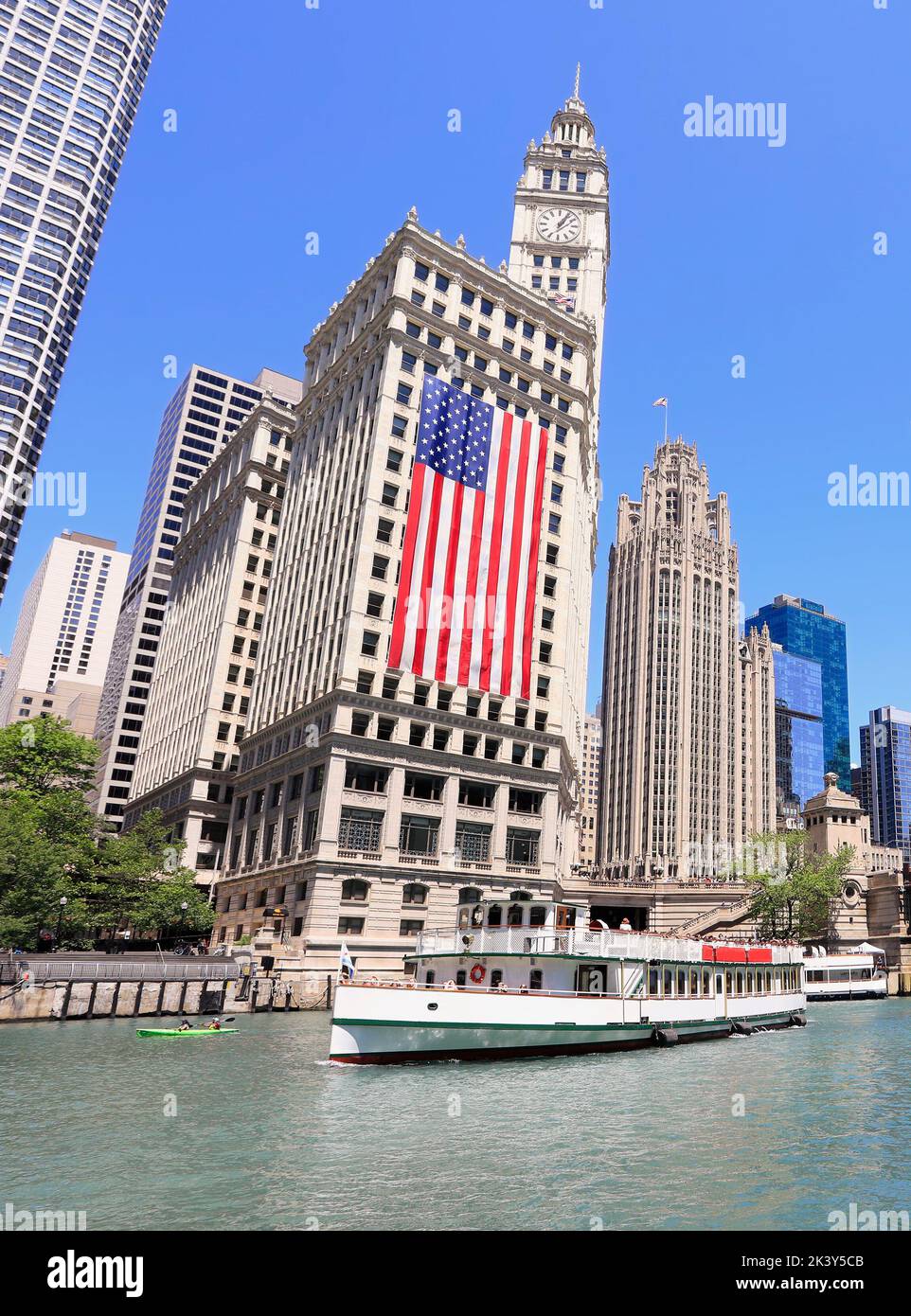 Chicago sightseeing cruise and skyline on the river including a huge American flag, Illinois, USA Stock Photo