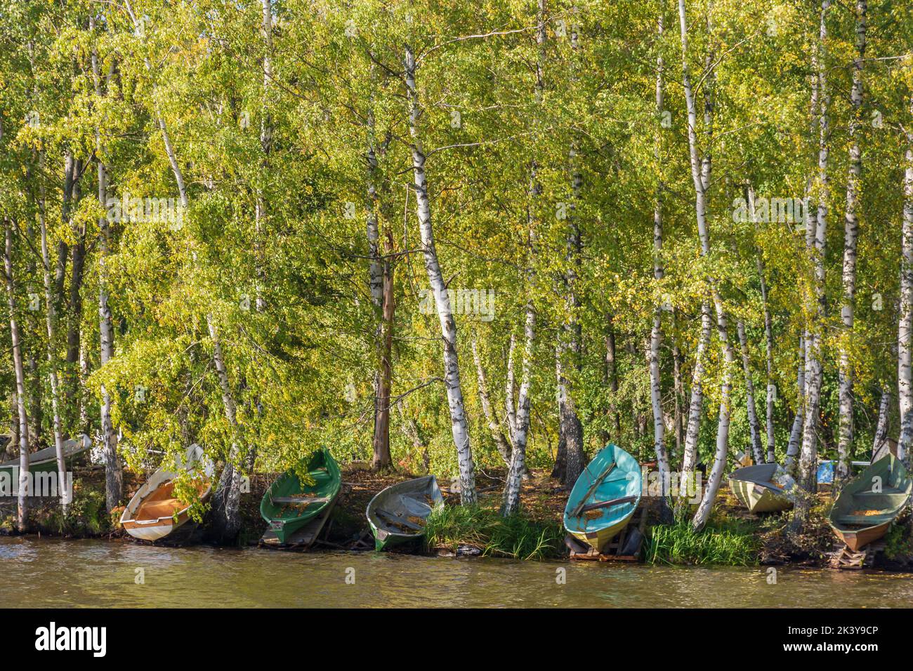 Rowboats by Pyhäjärvi lake in autumnal landscape in Tahmela Tampere Finland Stock Photo