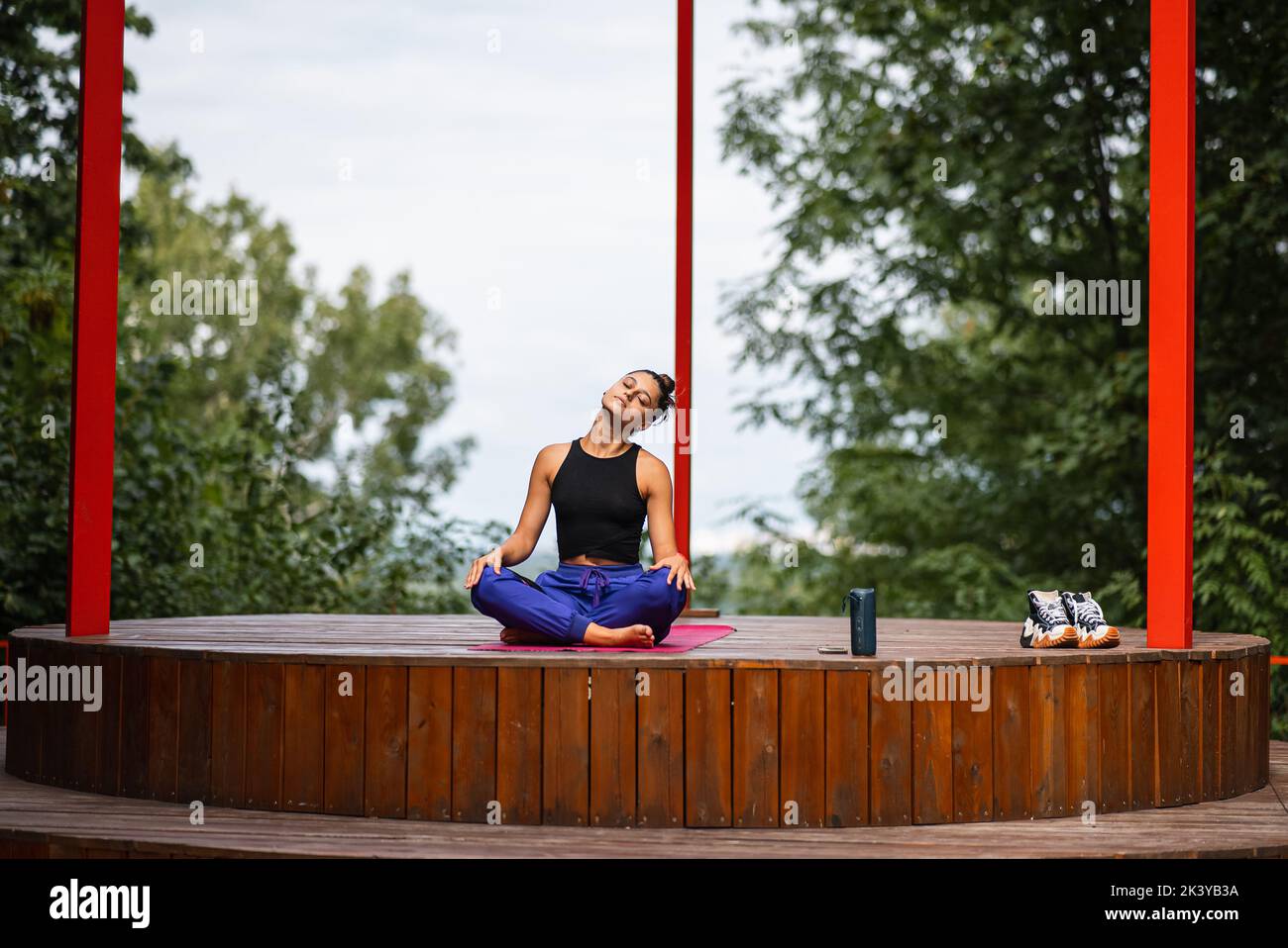 Young woman is practising yoga sitting in the lotus position Stock ...