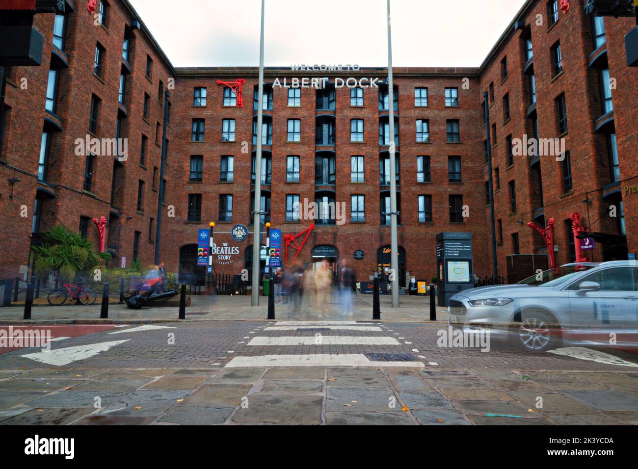 Slow shutter long exposure of an Uber taxi pulling up to pick up passengers at the Albert Dock Liverpool Stock Photo