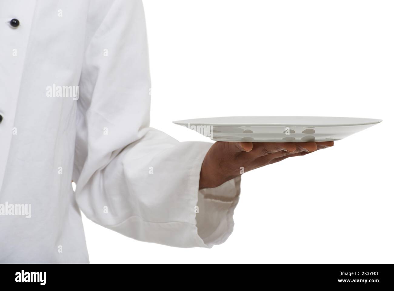 Place your food on this plate. an african chef holding a plate - Copyspace. Stock Photo