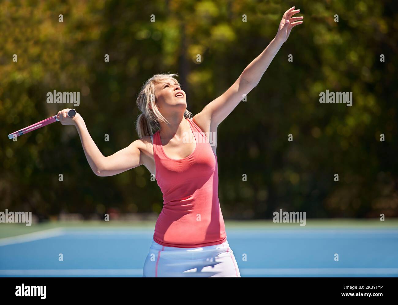 Shes going to be a tennis star. A young tennis athlete in the middle of a set. Stock Photo