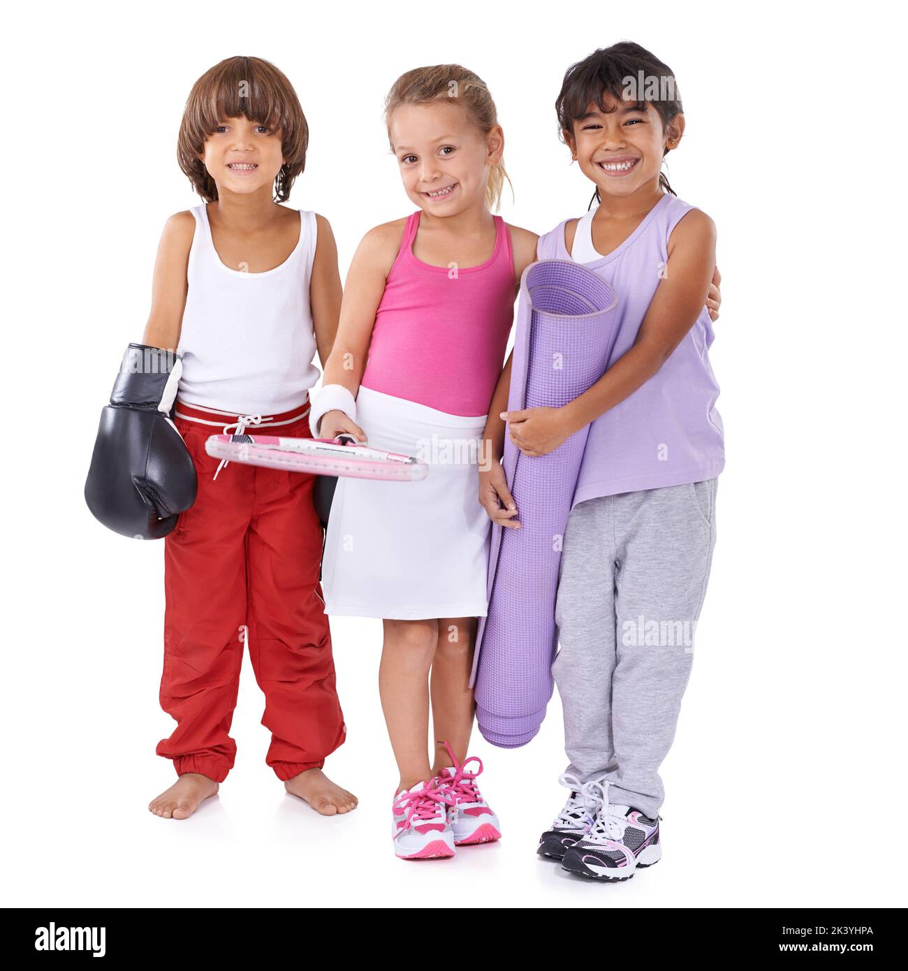 A look in to their future...A group of three children in sportswear isolated on white. Stock Photo