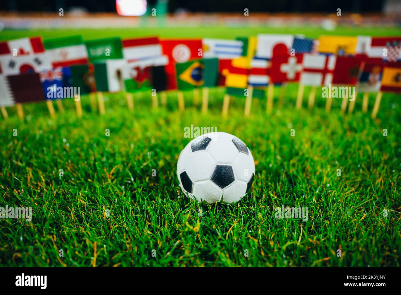 Football tournament. International games. Sport photo. Football ball and nationals flag including flag of Qatar, Brazil, Germany, France and others fo Stock Photo