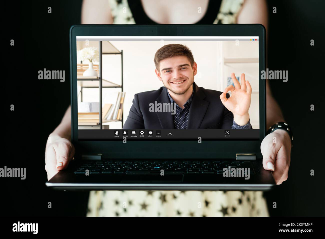 Video call. Online conference. Distance communication. Virtual meeting. Satisfied successful business man approving idea with ok gesture from screen o Stock Photo