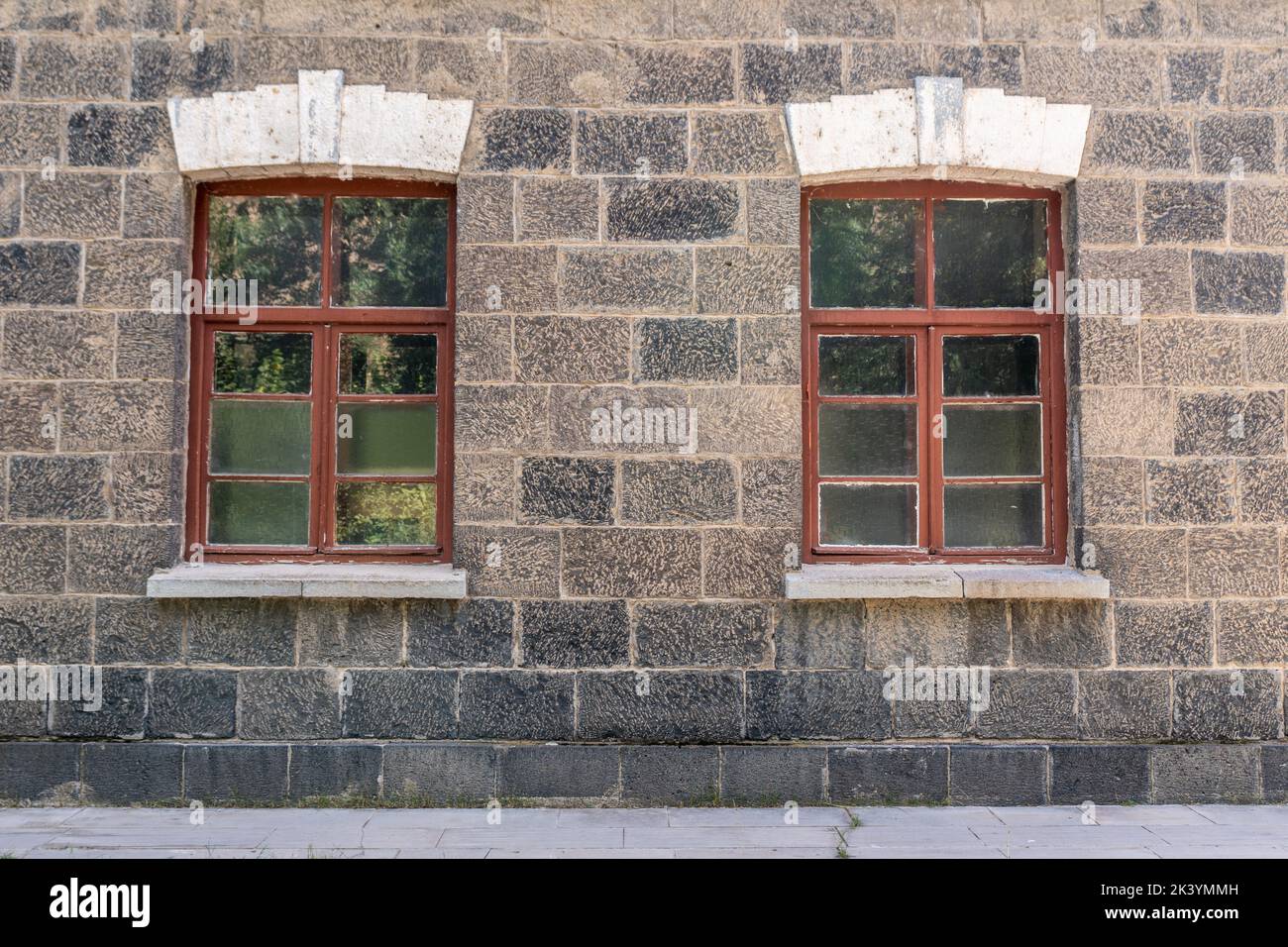 An old classic stone house with windows. Calssic stone walls and windows textures. High quality photo Stock Photo