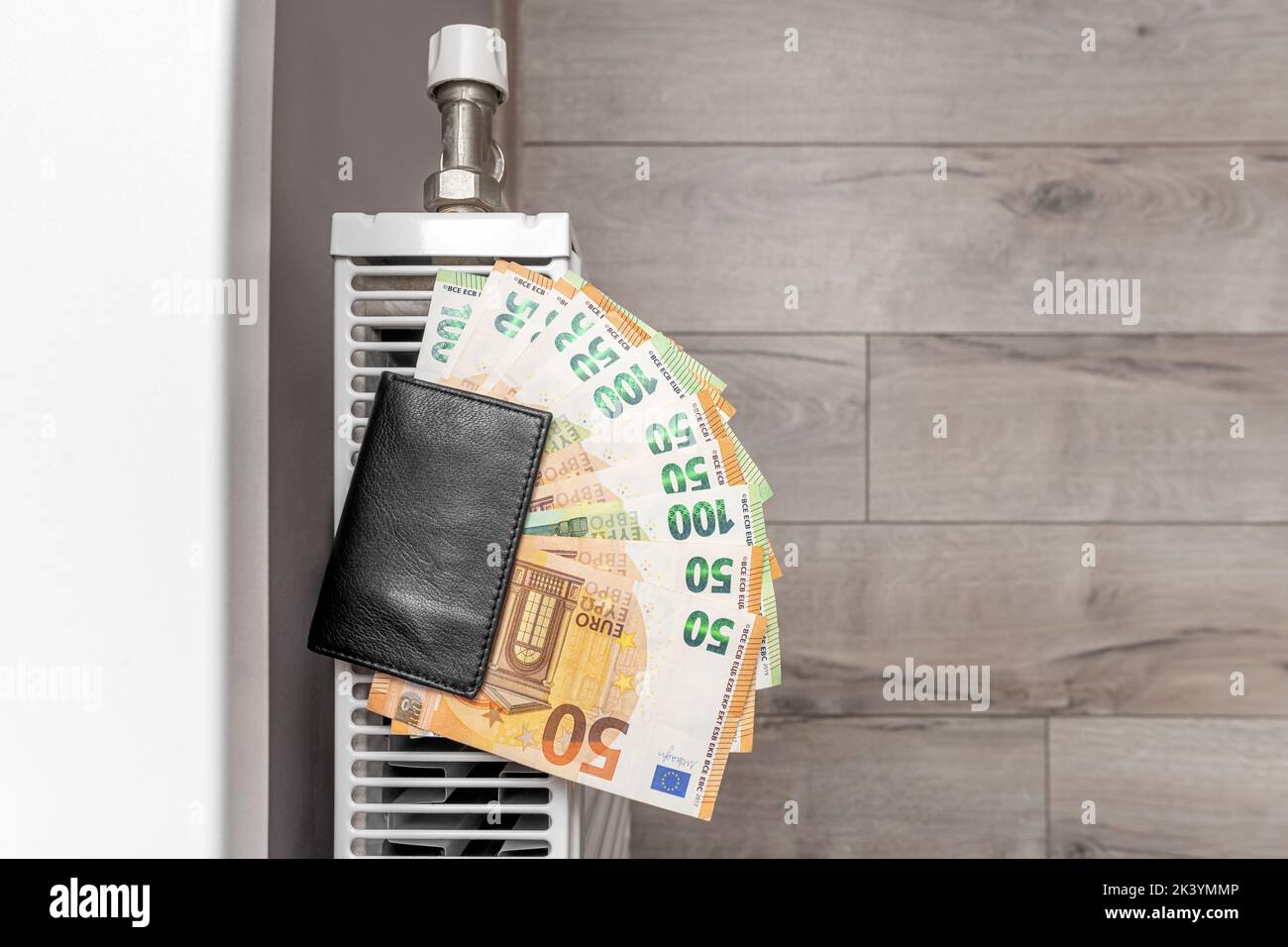 The money in the wallet is on the radiator. Stock Photo