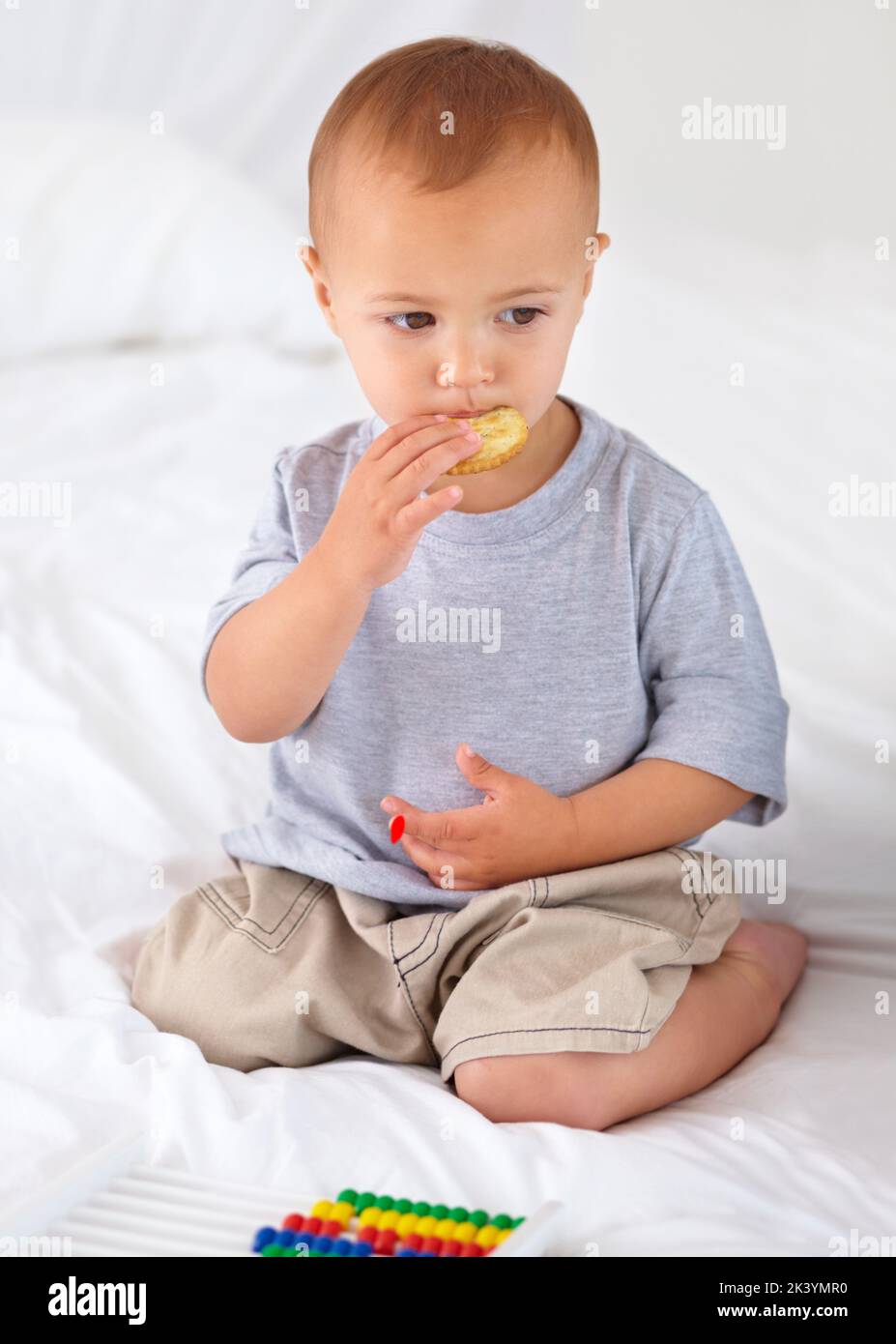 Eating a tasty cracker. A cute little boy eating a tasty cracker Stock