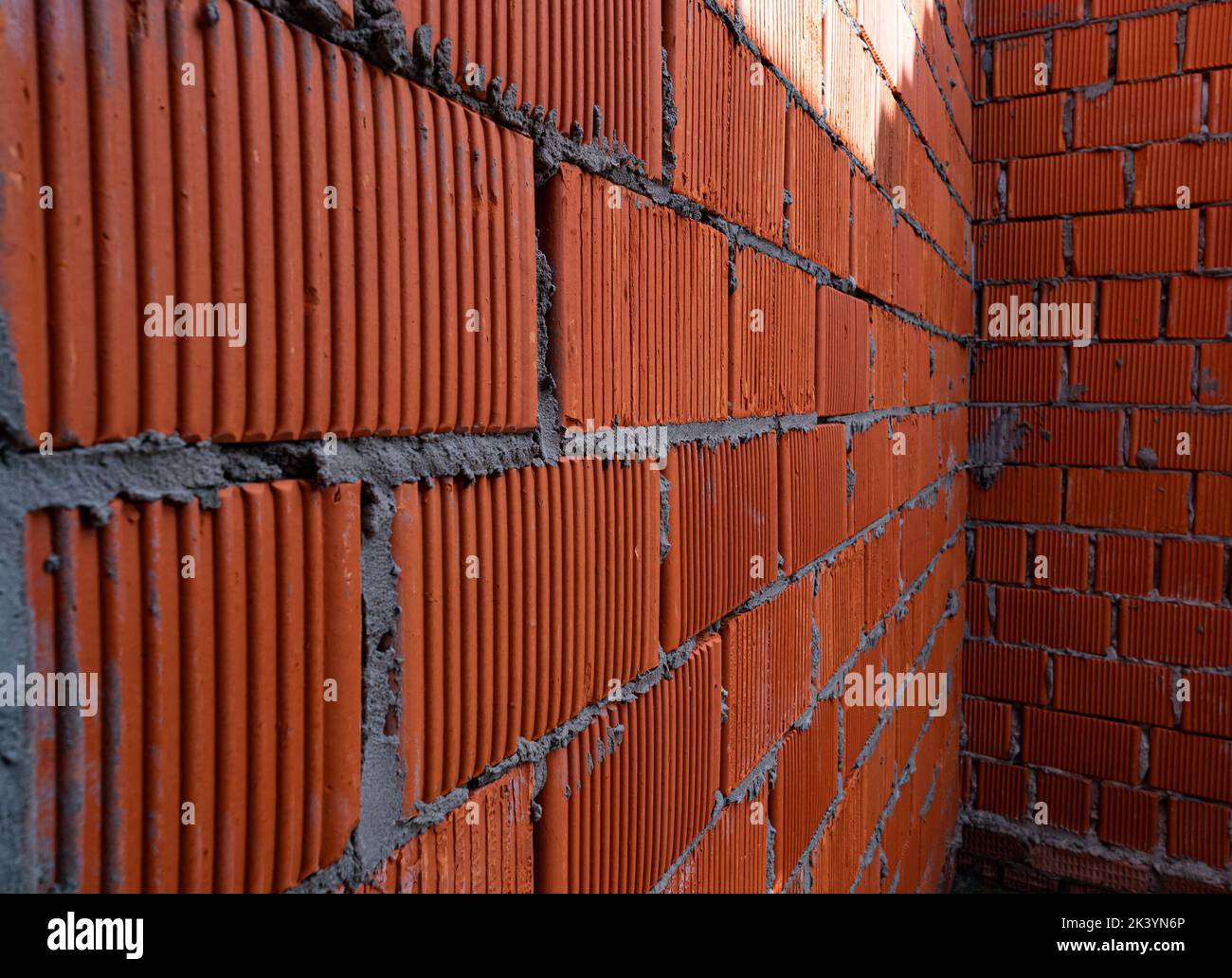 Brick wall of rough masonry. Large bricks in close-up. Walls in roughing. Brick wall texture Stock Photo