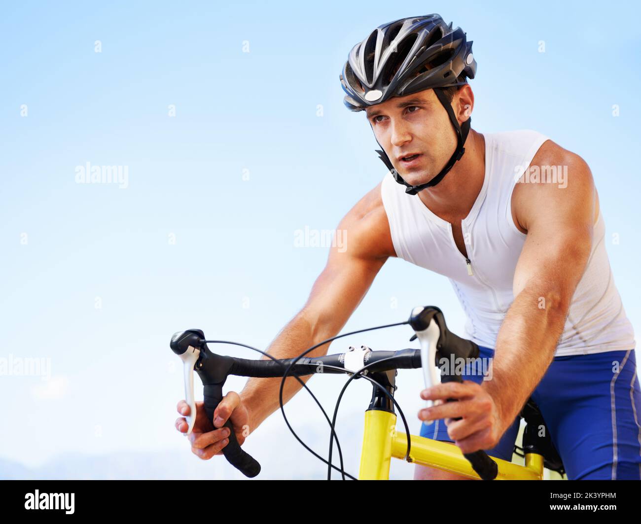 Enjoying the scenery while exercising. Cropped view of a cyclist cycling along an ocean road. Stock Photo