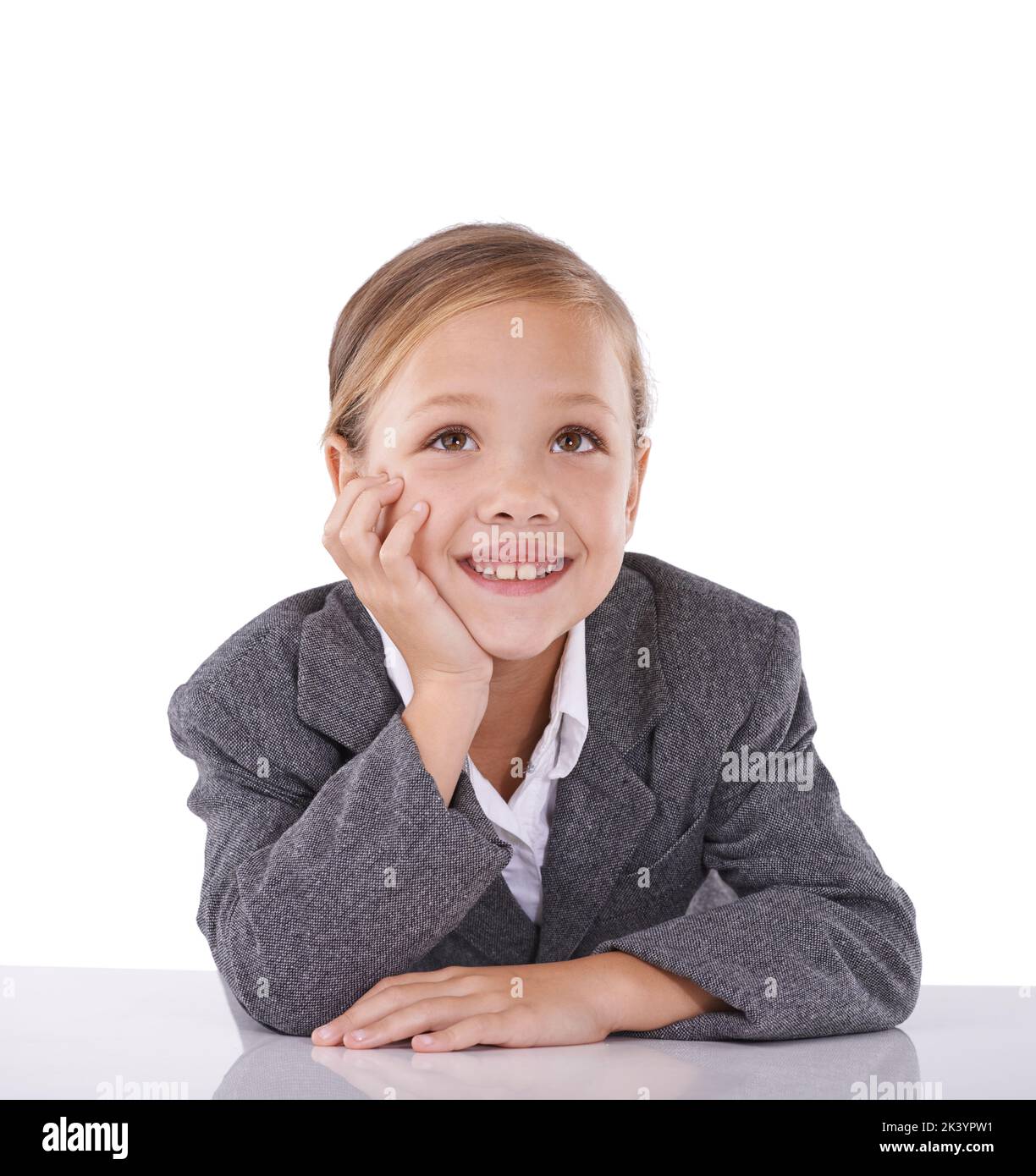 Shes dreaming big already. Studio shot of a cute little girl dressed like a businessperson. Stock Photo
