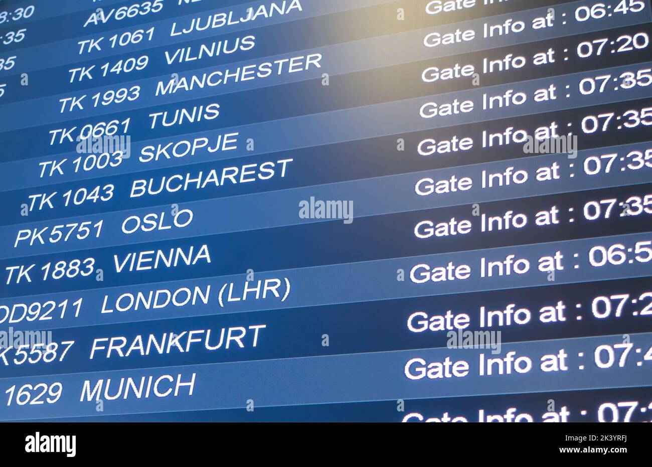 Photo of display in international airport with names of flights and cities. Stock Photo