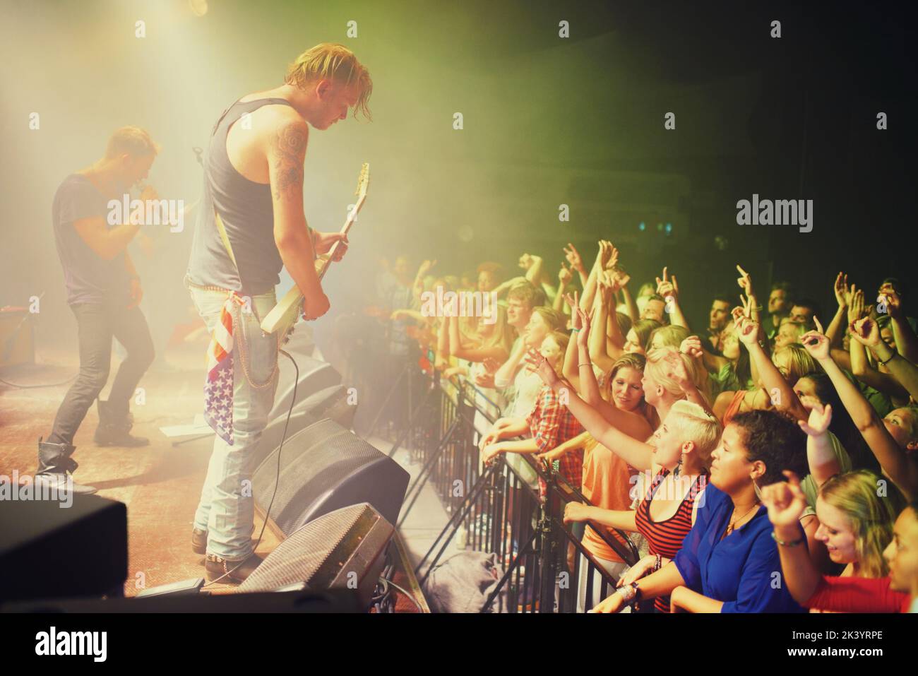 The most epic show of their lives. Young people getting into the music at an awesome concert. Stock Photo