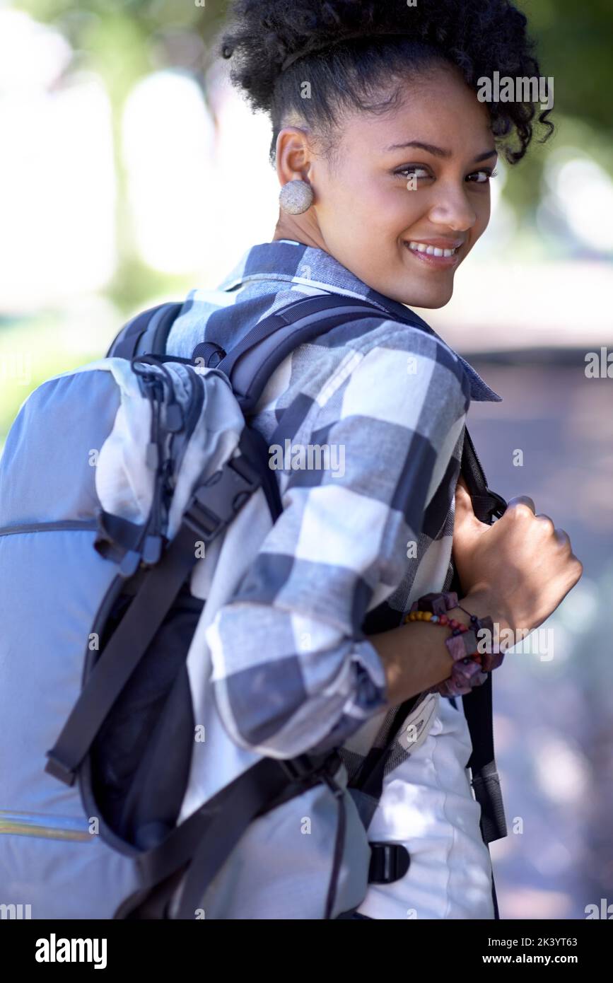 Flashing you a smile. An attractive young college student standing ...